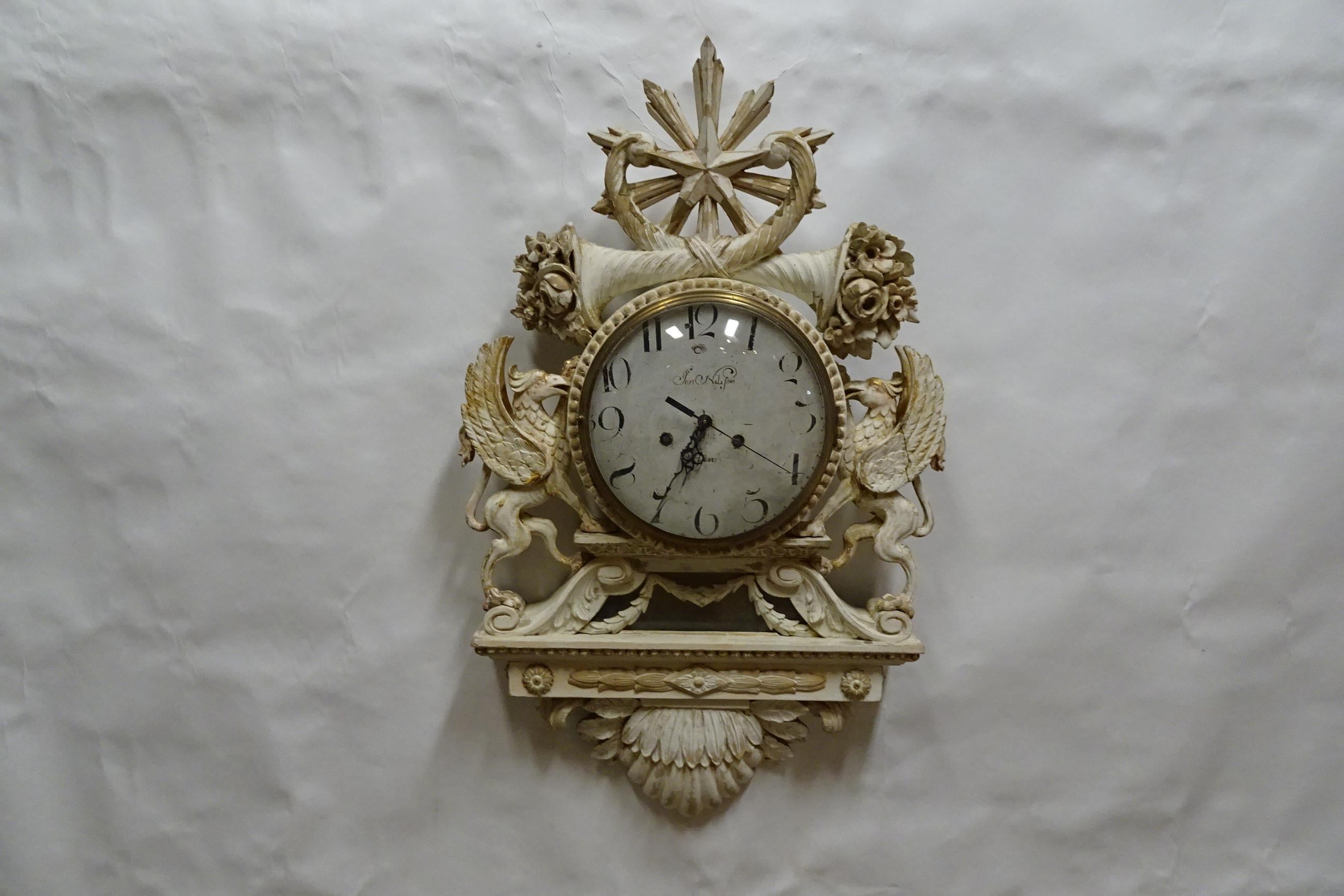 This is a 100% Original Finish Swedish Gustavian Style Wall Clock. it has had a Reproduction face and new battery works installed. you have a choice of chimes, volume nob and an Off switch.