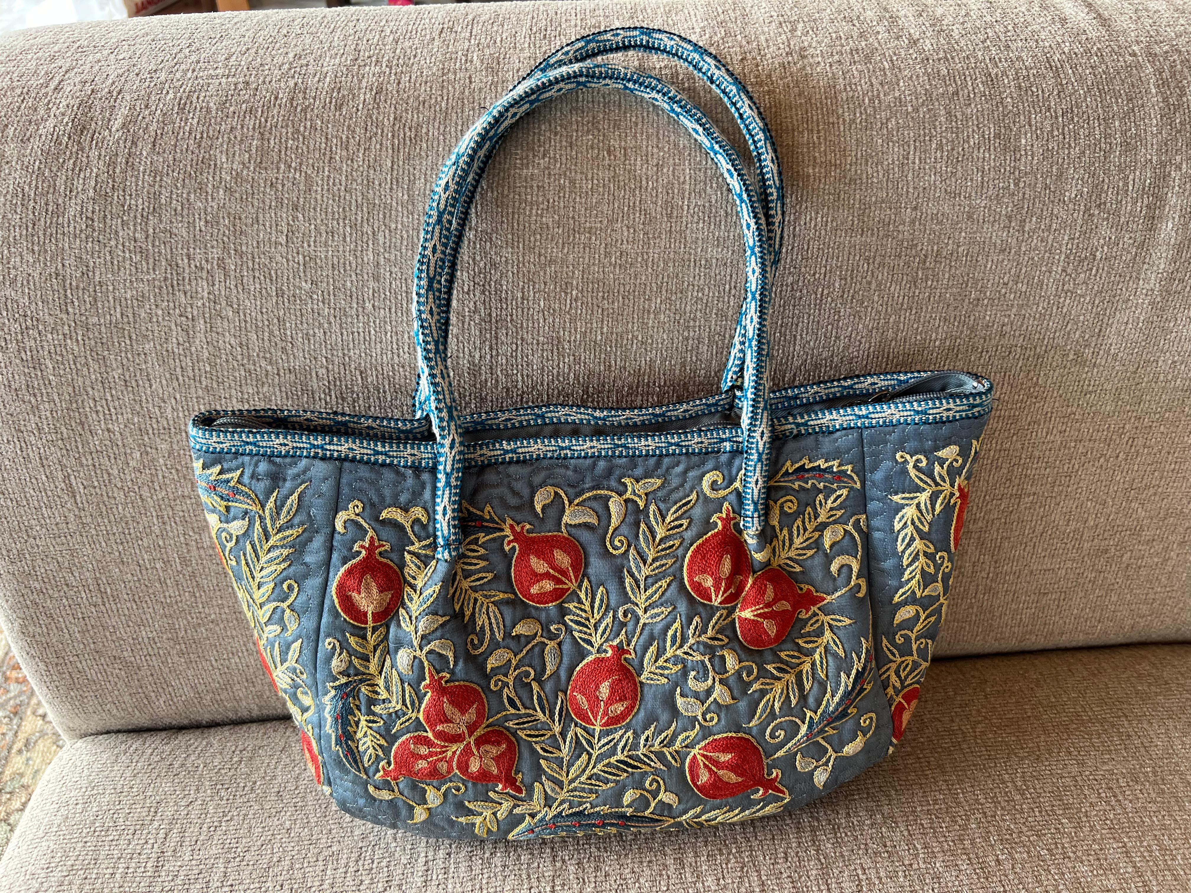 Elevate your style with this exquisite hand-embroidered Suzani handbag, crafted from 100% pure silk. Blending the beauty of traditional Uzbek Suzani embroidery with a modern aesthetic, this bag is a true statement piece for any