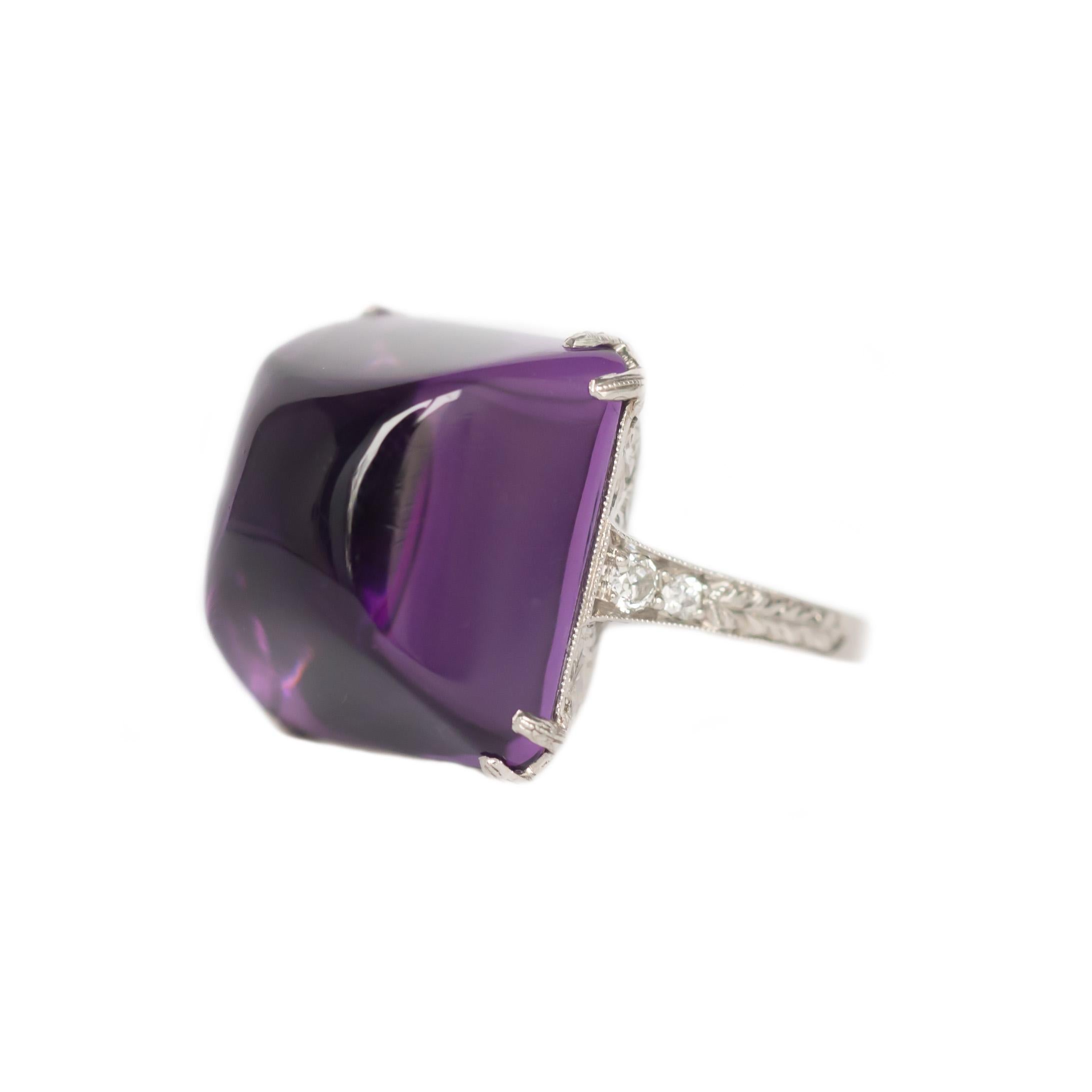 Ring Size: 5.25
Metal Type:  Platinum [Hallmarked, and Tested]
Weight: 8.8  grams

Center Stone Details:
Type: Amethyst, Natural
GIA REPORT # 2205851670
Weight: Approximate 10 carat
Cut: Sugarloaf Cabachon
Color: Purple


Side Diamond