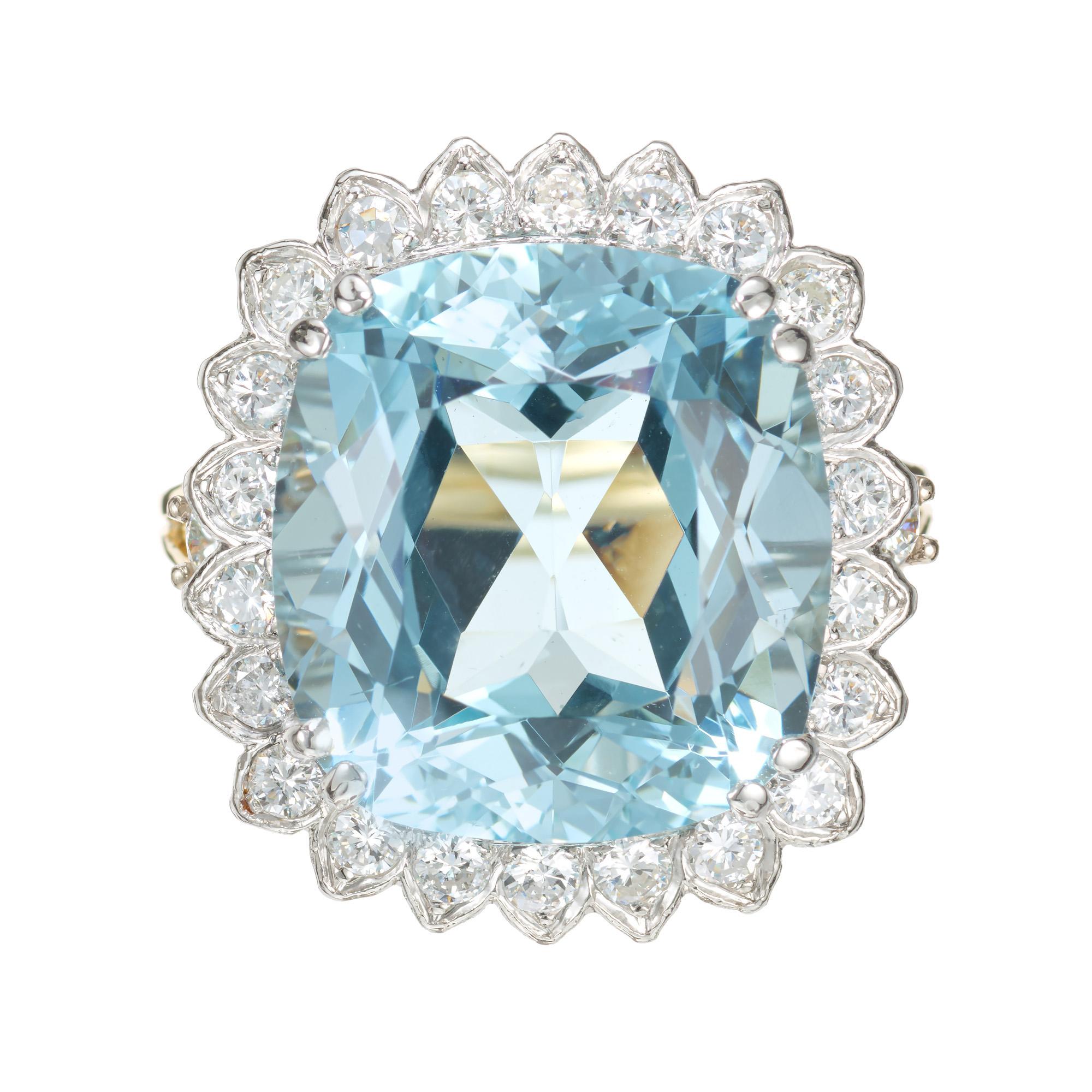 Aqua and diamond cocktail ring. 10.00ct cushion cut center aqua with a halo of 22 round full diamonds set in a two-tone handmade cocktail setting. The untreated sits in a 18k white gold crown with an 18k yellow gold shank accented with two round cut