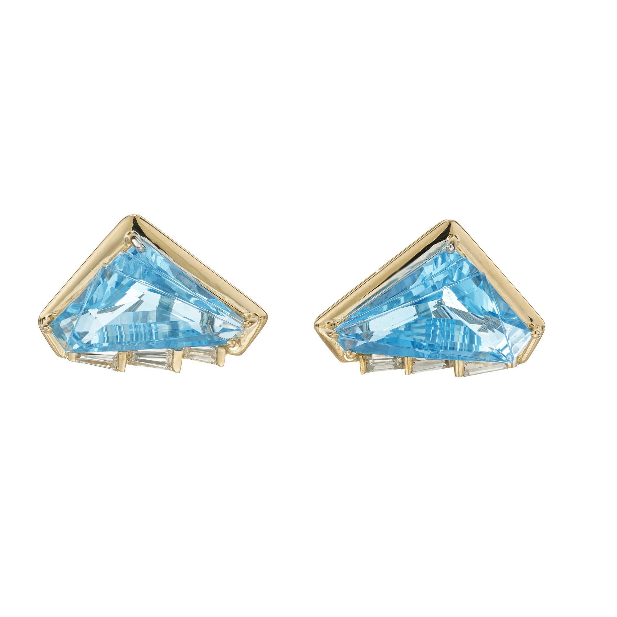 Brilliantly made bright blue 10.00 carat topaz triangular fantasy cut gemstones, set in custom made 18k yellow gold clip post settings accented by 6 tapered diamond baguettes. These beautiful designer style earrings are a timeless and versatile