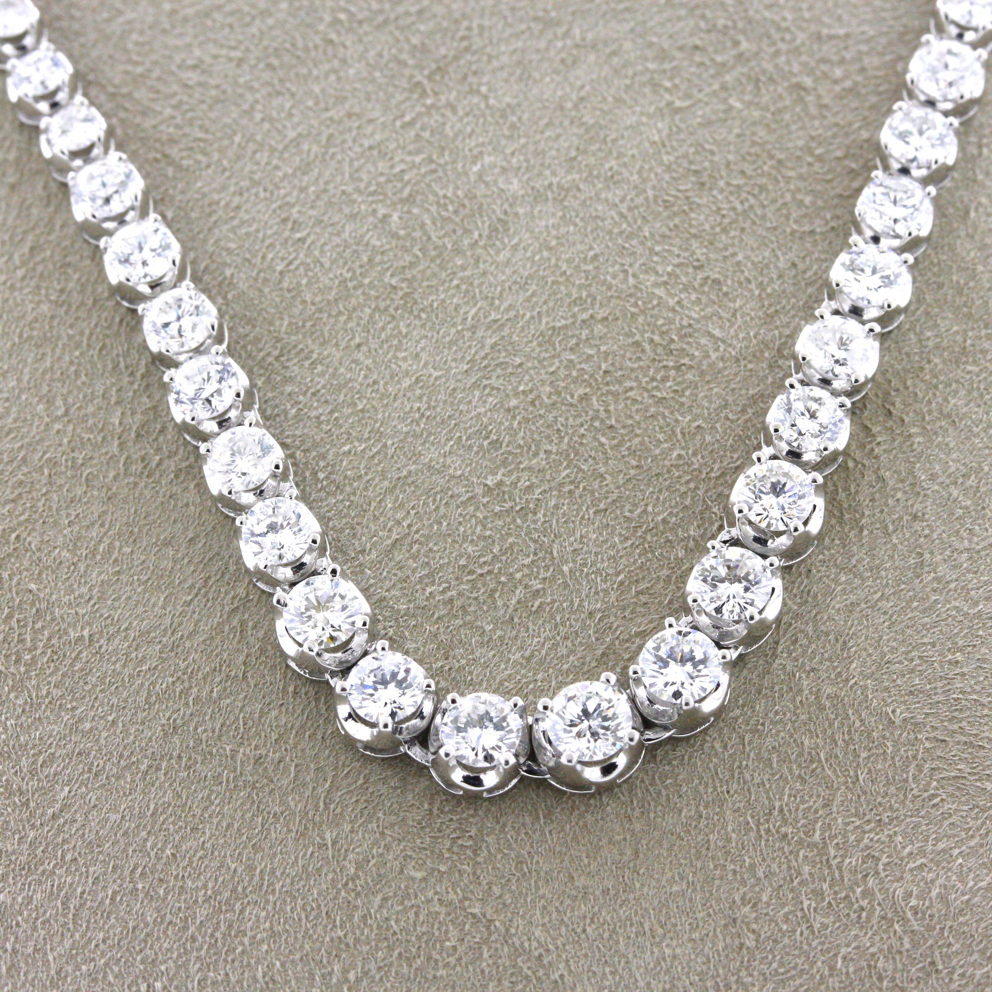 A lovely platinum made tennis necklace featuring 10.00 carats of round brilliant-cut diamonds. The largest diamonds in the center of the necklace weigh about a quarter carat and graduate slightly on the ends. Hand-fabricated in platinum, a classy