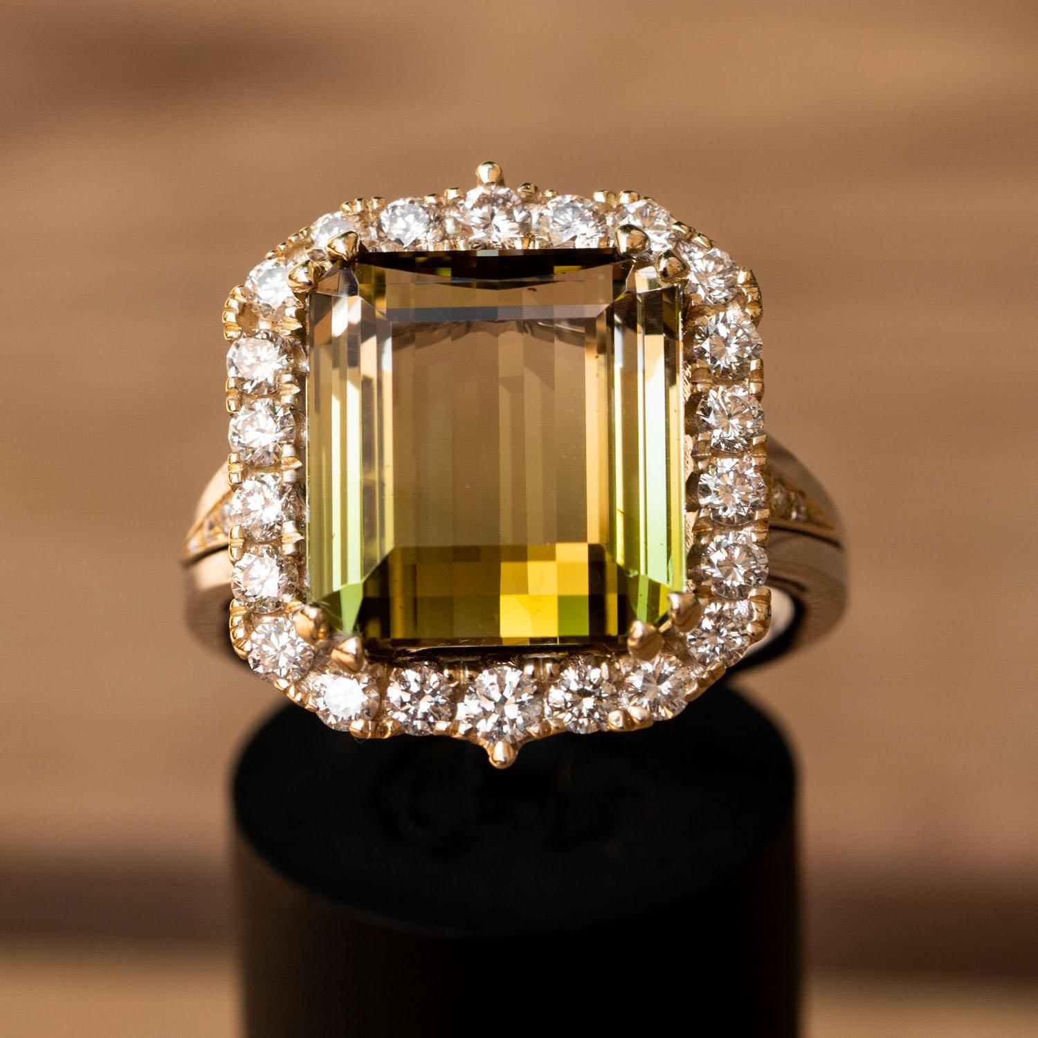 This emerald cut, natural bi color natural tourmaline diamond ring is simply stunning! The large 10.00 carat natural central tourmaline surrounded by 1.01 carat sparkling natural diamonds.

This genuine bi-color Tourmaline gemstone displays a medium
