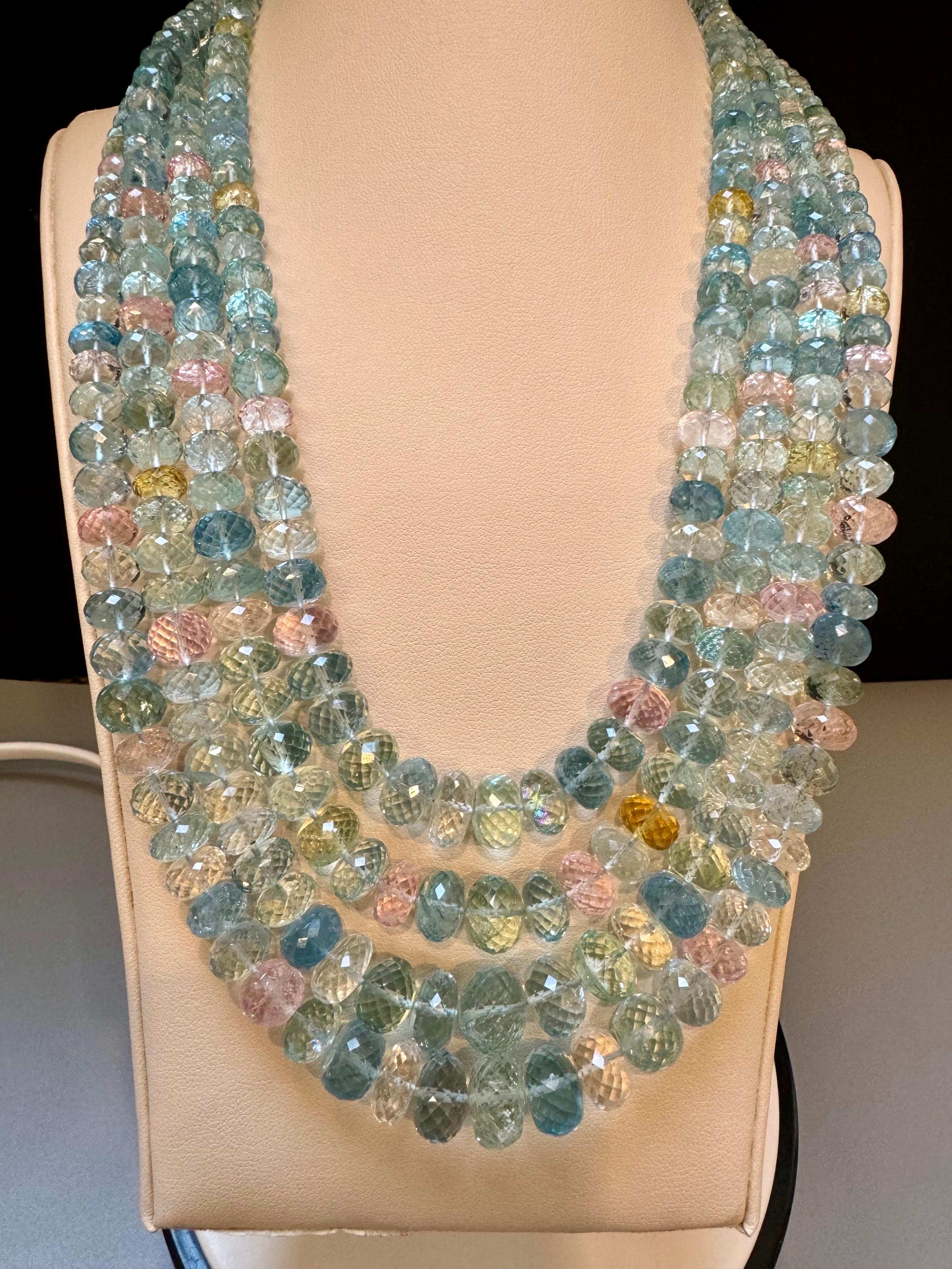 1000 Carat Natural Fine  Aquamarine Graduating Bead Necklace, Four Strand in Metal Clasp
Natural Multi color Aquamarine Round Beads in graduating size
Necklace has 4 strand
Approximately 4  mm to 8mm  bead
Clasp is not gold 
20 Inches long
Faceted