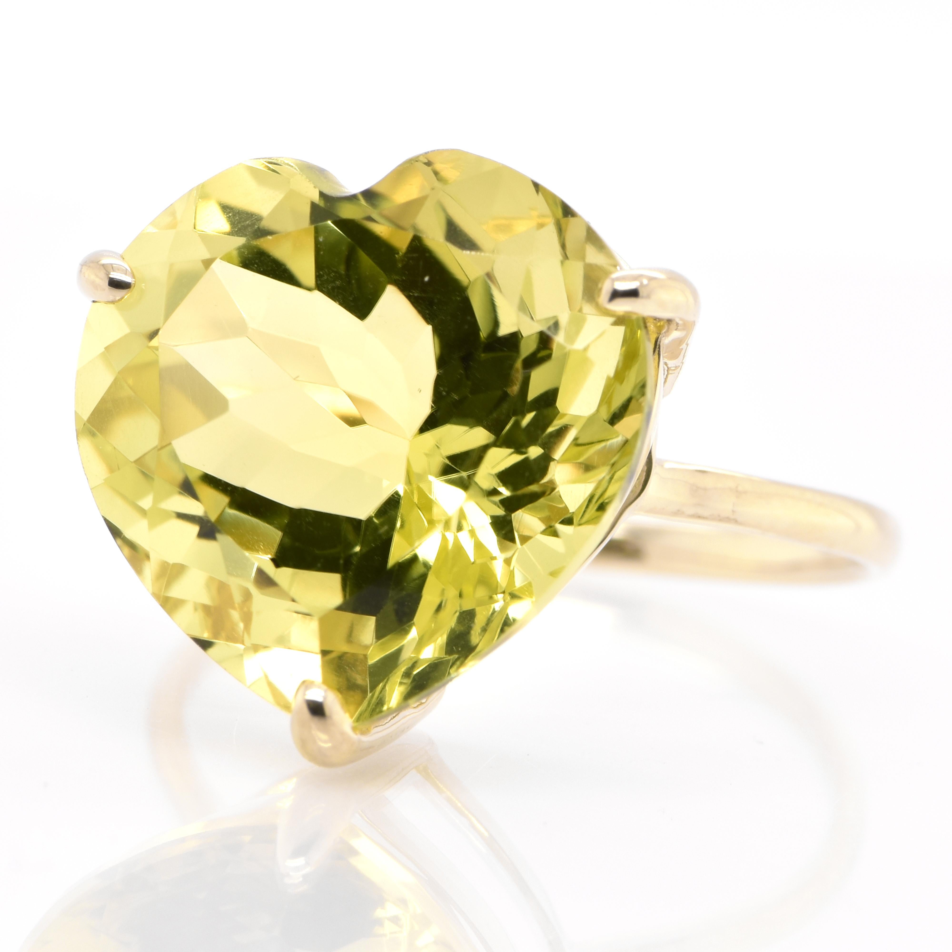 A beautiful Cocktail Ring featuring a 10.00 Carat, Natural Heart Cut Lemon Quartz set in 18 Karat Yellow Gold. From the earliest times, people confused Peridot with other gems such as Emerald and Topaz. Some historians believe that Cleopatra’s
