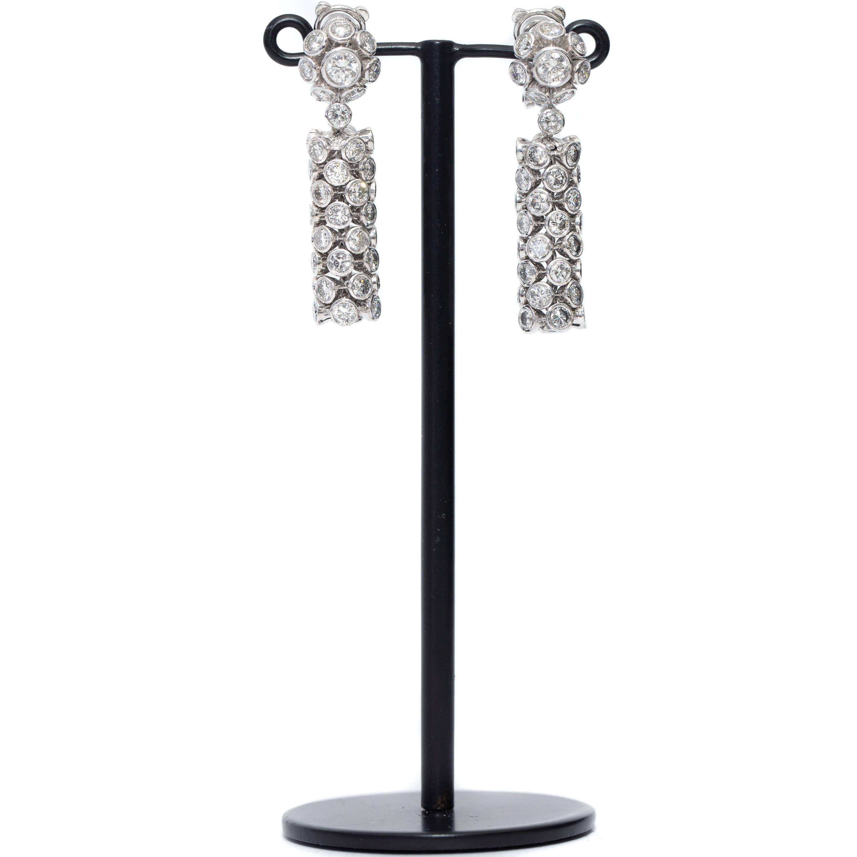 These Spectacular Bezel set Diamond drop earrings featuring 10.00 Carats of sparkling White Diamonds perfect for any occasion beautifully set in 18 Karat White Gold, British Hallmarked. 
