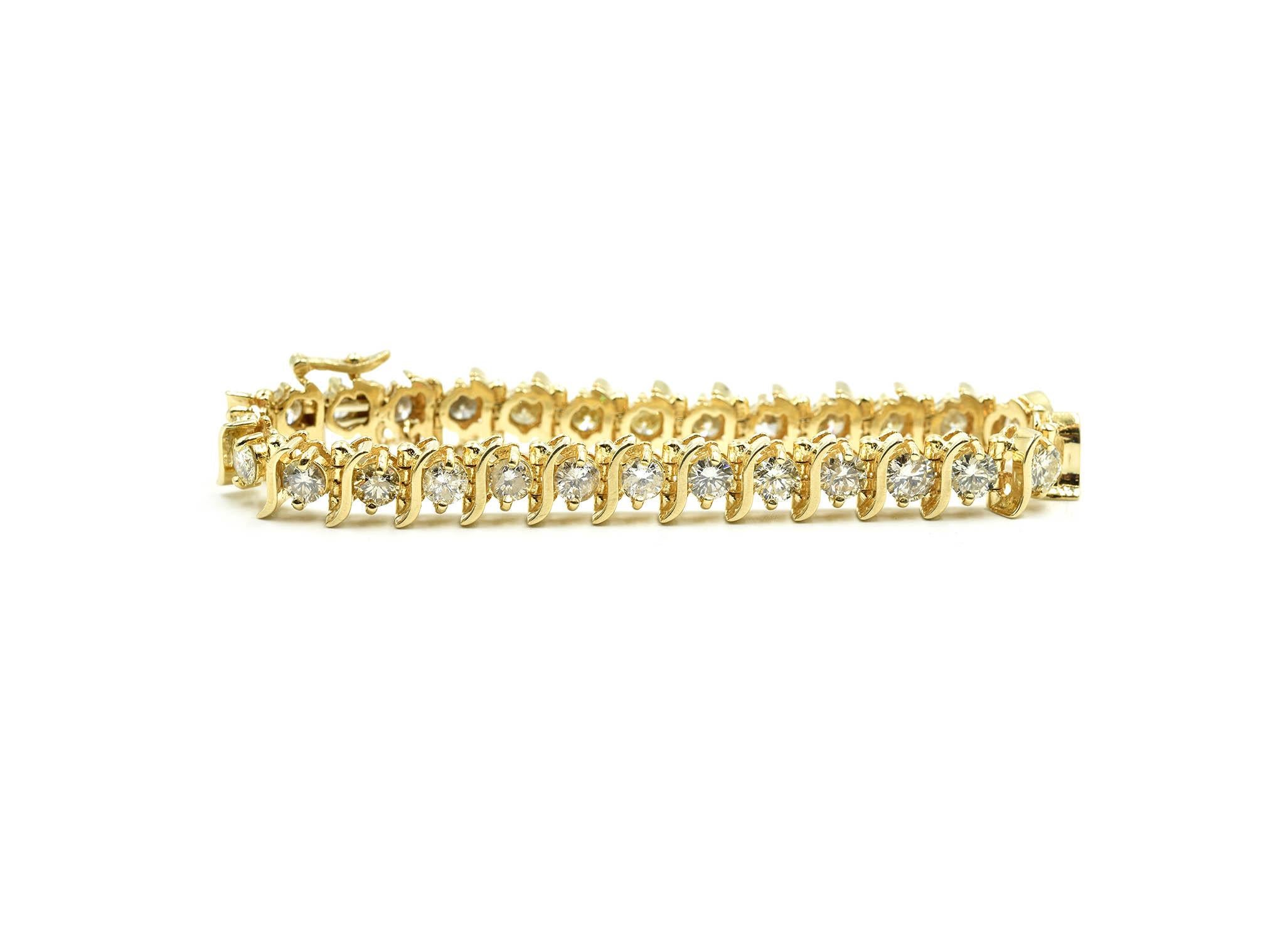 Designer: custom design
Material: 14k yellow gold
Diamonds: 28 round brilliant cut diamonds = 10.00 carat total weight
Color: J
Clarity: SI3
Dimensions: bracelet will fit 6 3/4-inch wrist
Weight: 26.68 grams
