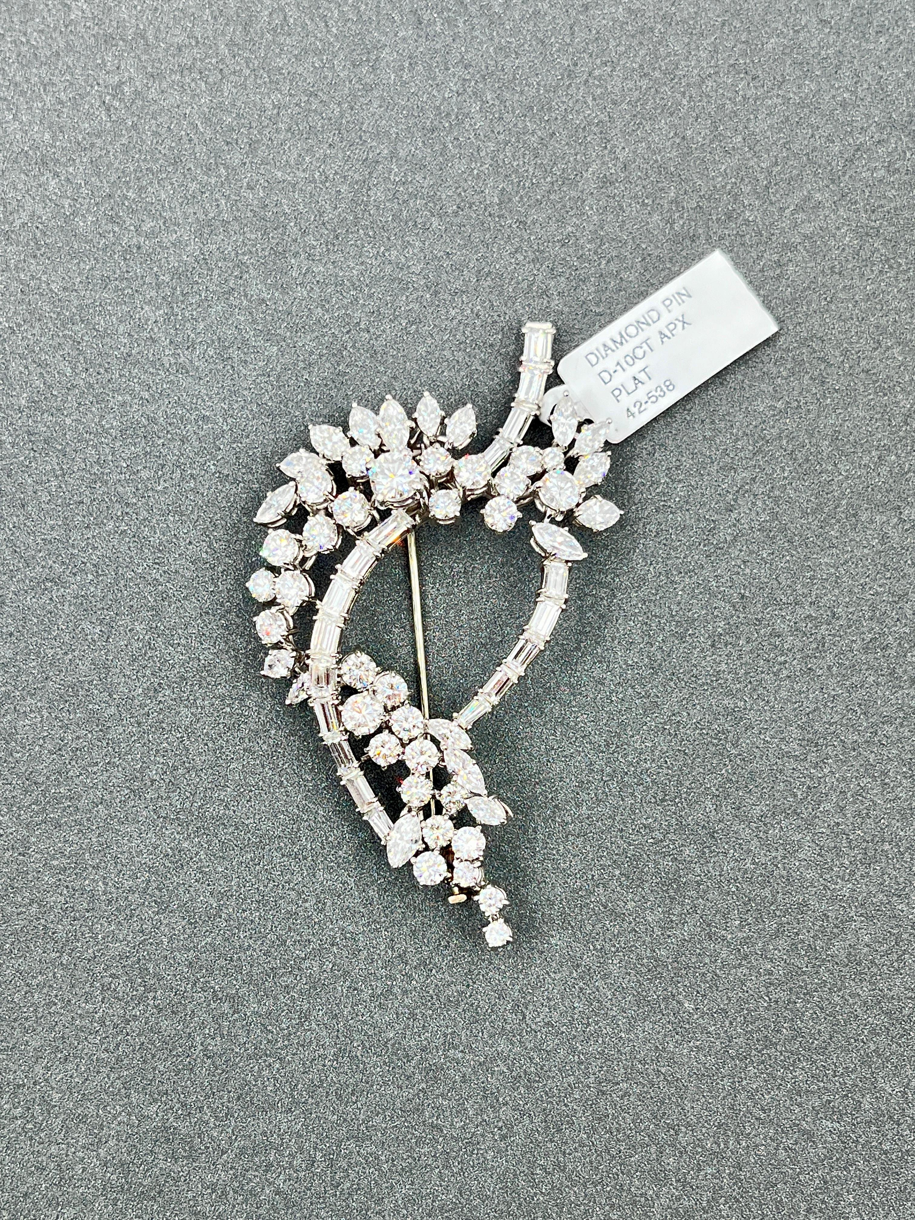 This antique brooch features round, marquise, and baguette shape diamonds weighing approximately 10.00 ct. The diamonds are set in platinum and graded E/F in color, and VS1/VS2 in clarity.

