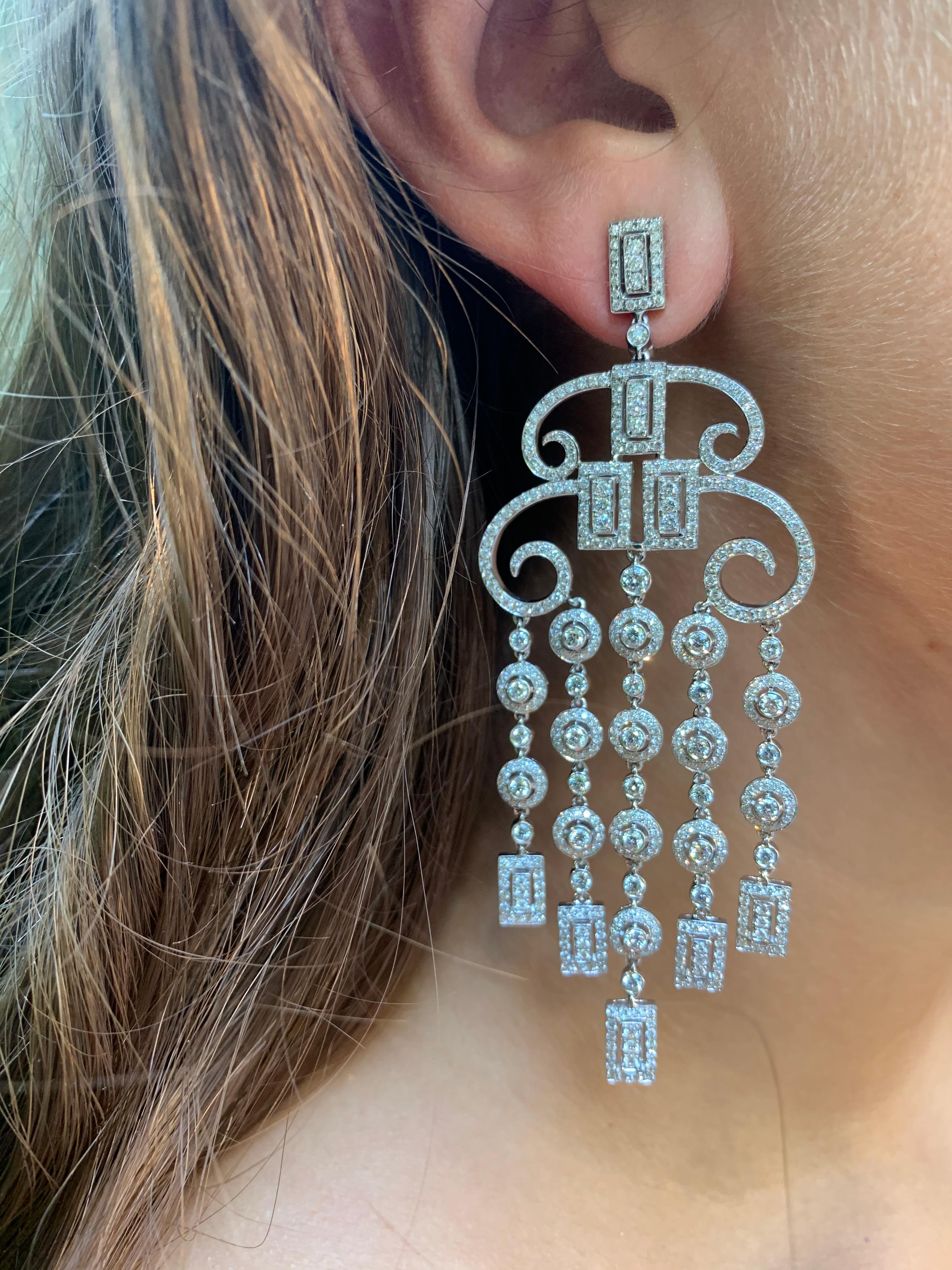 Fabulous, large, glamorous Art Deco style openwork diamond and 18K white gold chandelier earrings. Round cut diamonds total weight approximately 6 carats. Diamonds G-H, VS.
3.4 inches long
Very fine quality
Classic circles, swirls and rectangles