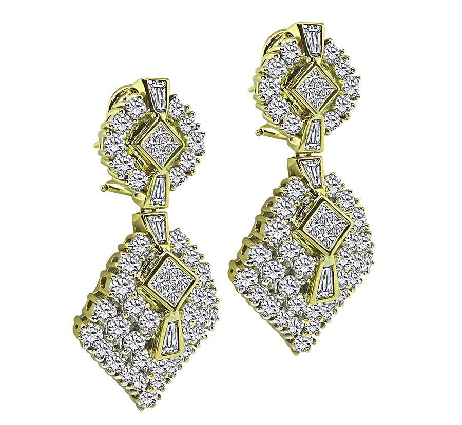 This is a charming pair of 18k yellow gold dangling earrings from the 1970s. The earrings feature sparkling round, baguette and princess cut diamonds that weigh approximately 10.00ct. The color of these diamonds is H-I with VS clarity. The earrings