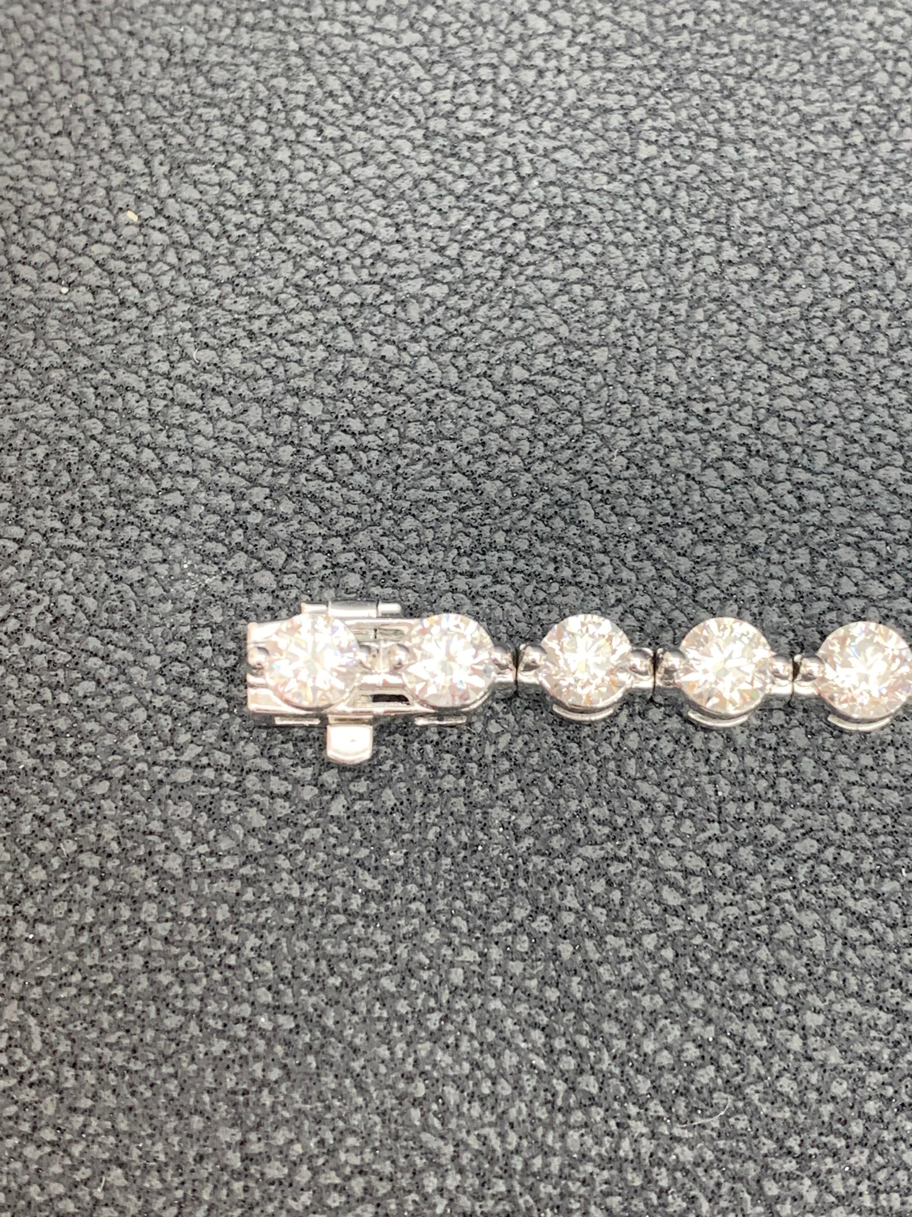 Line bracelet features round brilliant diamonds each set in a 2 prong setting. Total weight of the diamonds is 10.01 carats. Made in 14k white gold. Approximately 7 inches in length.
