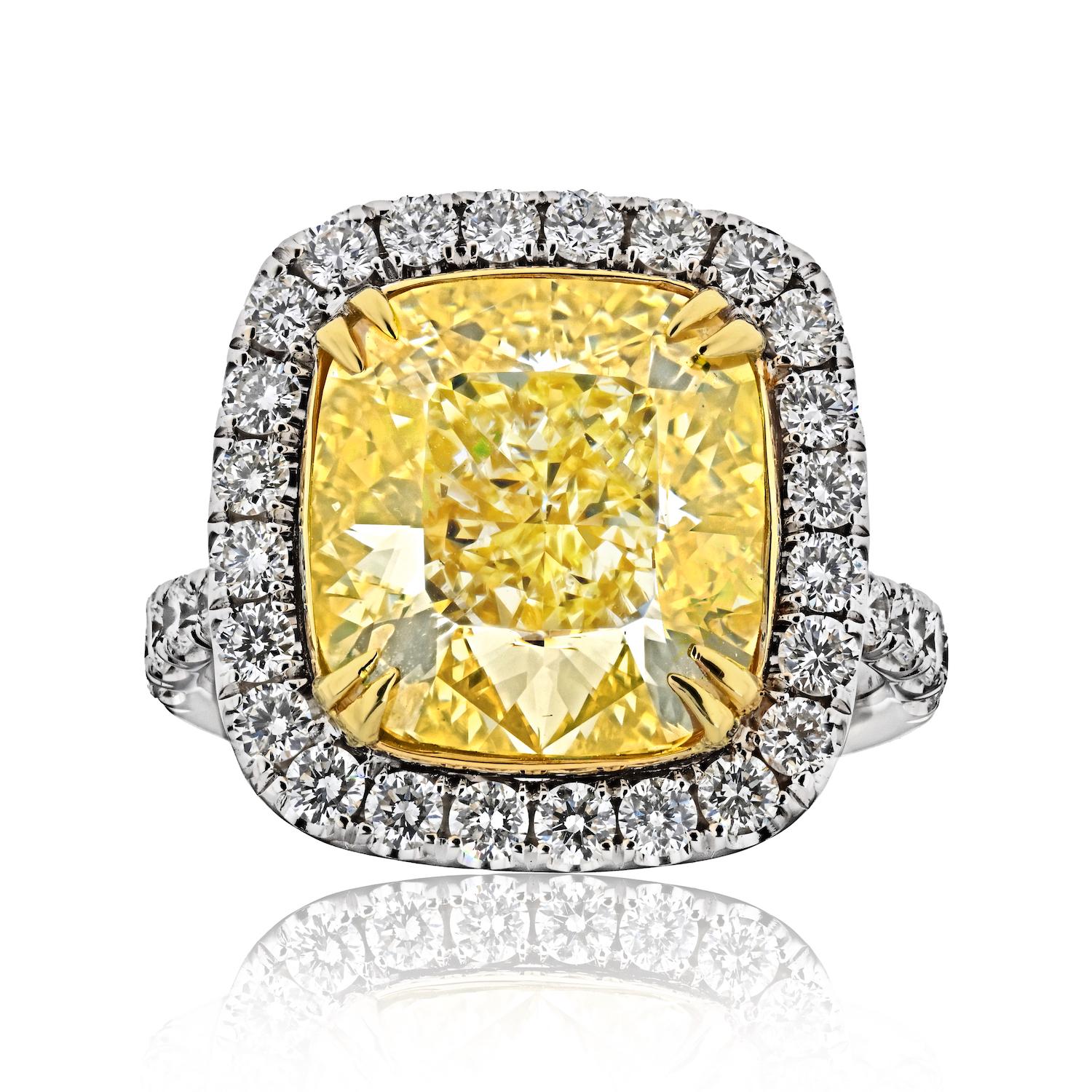 Elevate your style with this exquisite Fancy Yellow Intense Cushion Cut Diamond Ring. At its heart lies a stunning 10.03-carat cushion-cut diamond, certified by GIA as Fancy Intense Yellow in color and boasting a VS2 clarity. This magnificent gem is