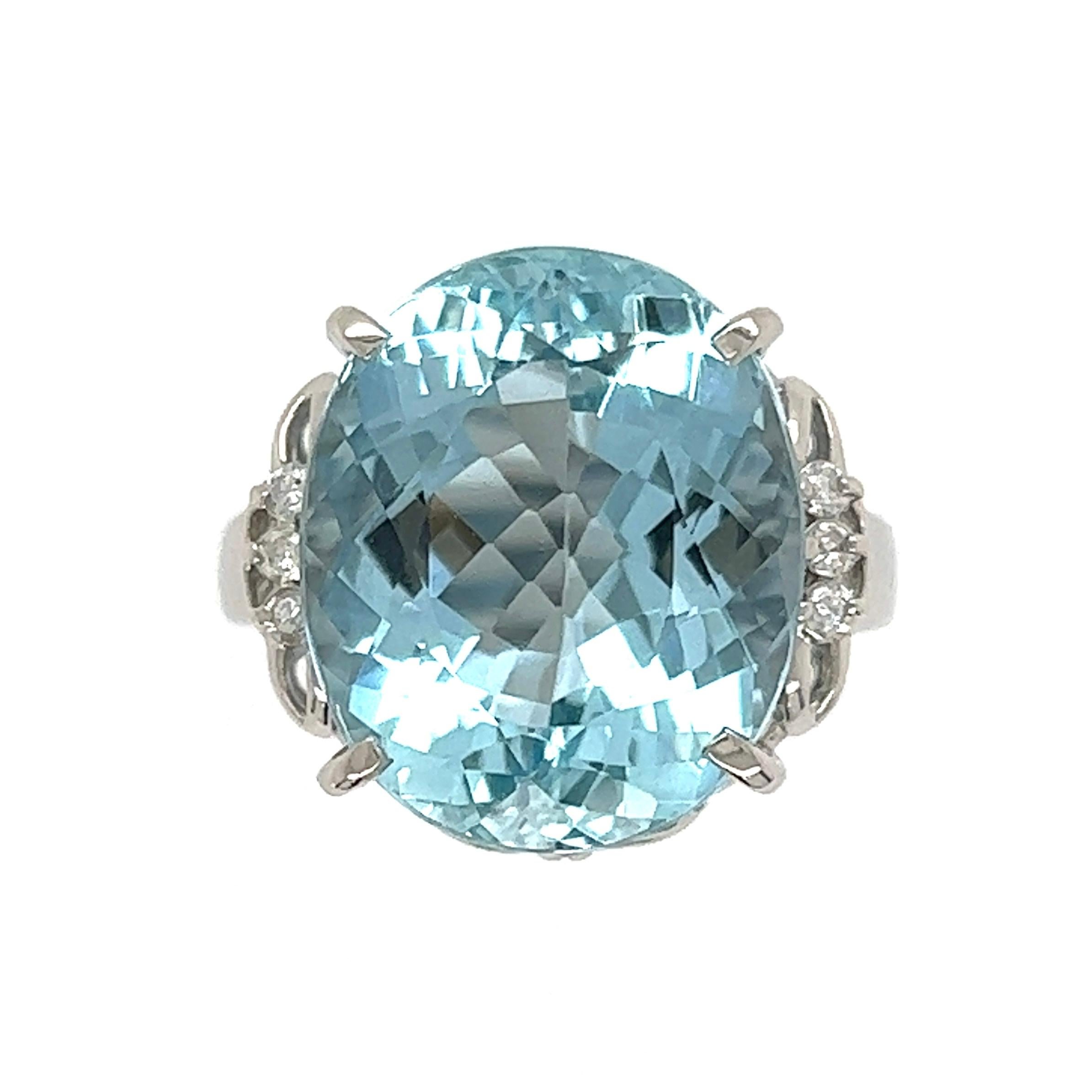 Simply Beautiful! Aquamarine and Diamond Cocktail Ring centering a securely nestled Hand set Oval Aquamarine with Diamonds on either side, weighing approx. 0.08tcw. Hand crafted Platinum mounting. Dimensions: 1.05: l x 0.78” w x 1.10” d x 0.61” h