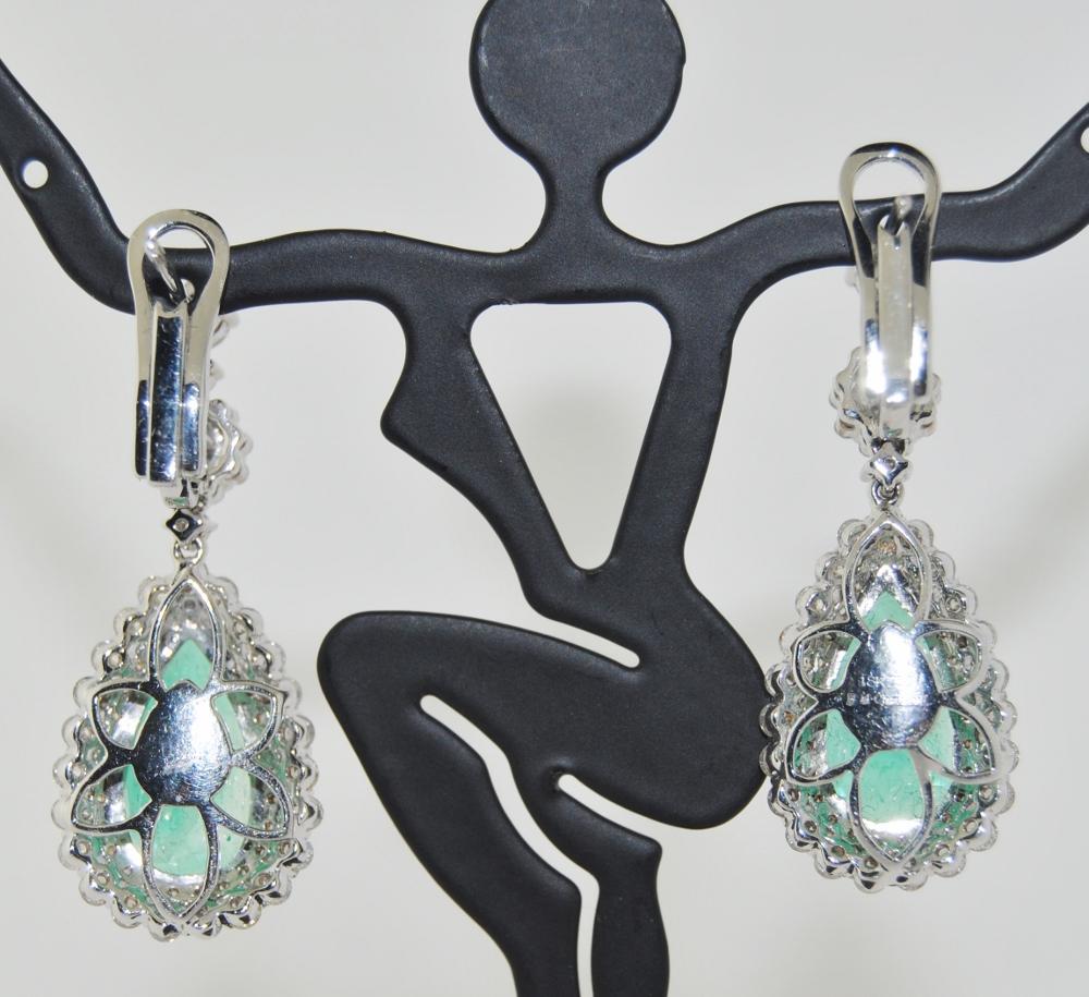 18K white gold drop earrings featuring 10.06 carats of pear shaped Emerald and 2.34 carats of round brilliant diamonds.  New earrings
