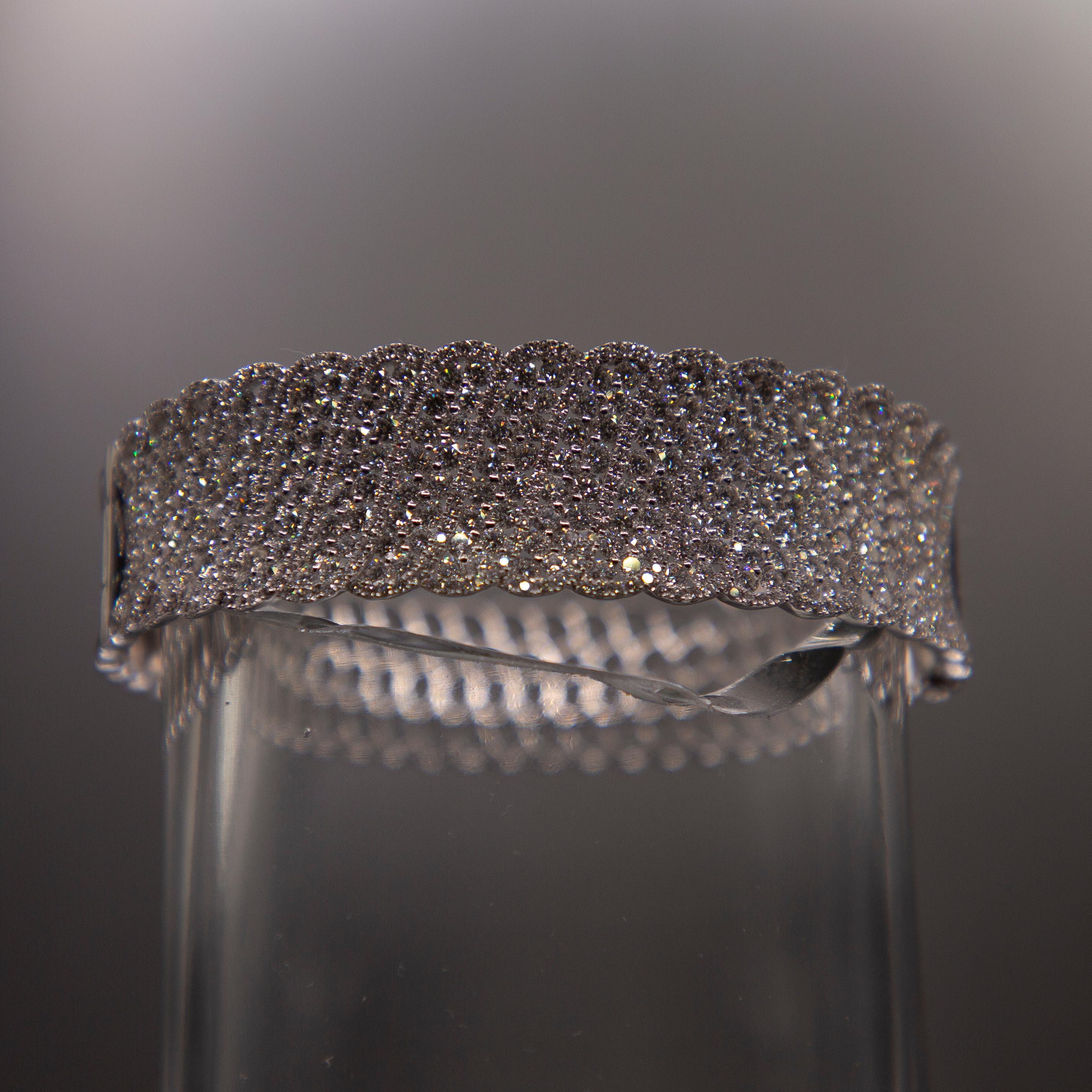A meticulously fabricated, lacy 18k white gold weave is spectacularly set with 684 perfectly cut, top collection diamonds weighing 10.06 carats total. F VS1 quality. The setting is accomplished with a proprietary, centuries- old Italian technique