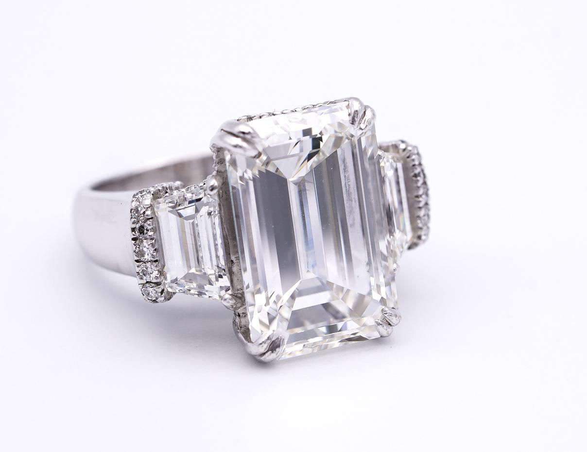 Stunning Emerald cut diamond ring with center diamond weighing 10.07 carats graded by GIA H color VVS2 clarity,  with an Excellent polish , and very good symmetry, finely crafted in Platinum flanked by 2 trapezoid diamonds on each side approximately