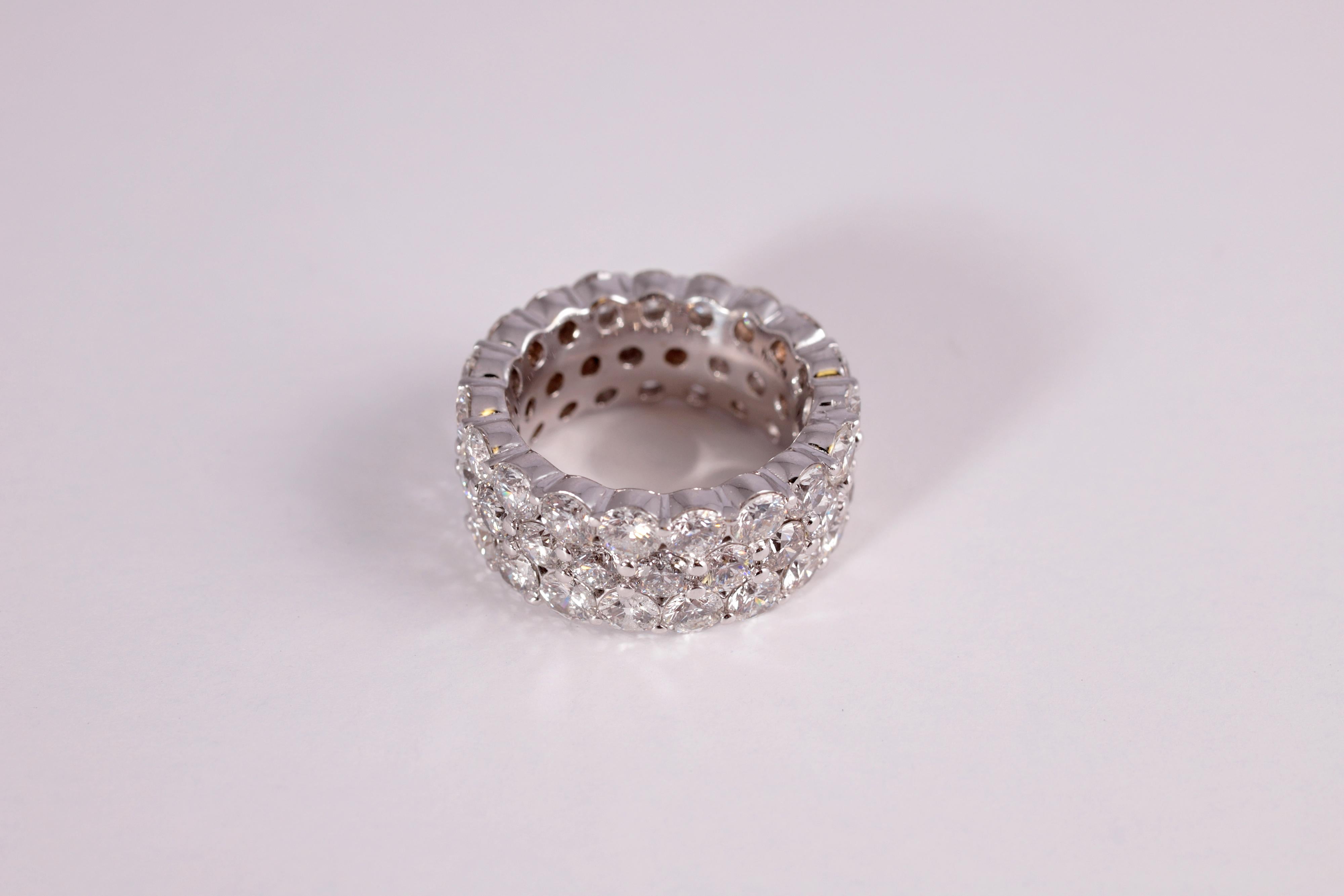 Sparkling does not even begin to describe this beauty!  Fifty-six shared prong, round diamonds make up this stunning ring, all in 18 karat white gold. Size 6 1/2.