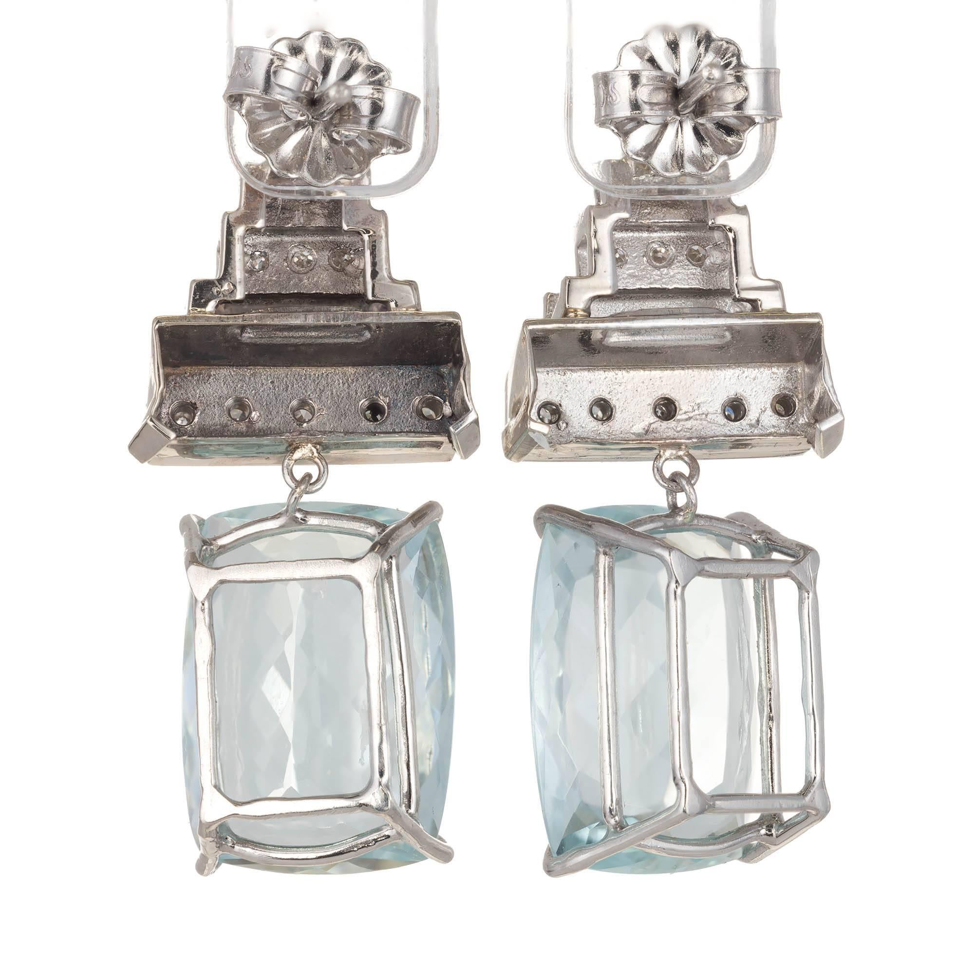 Art Deco aquamarine and diamond dangle earrings. Set in platinum with diamond Art Deco tops. Bright untreated antique cushion cut Aqua.

2 cushion cut Aquamarines aprox. total weight 9.94cts
30 round diamonds, approx. total weight .15cts, H – I