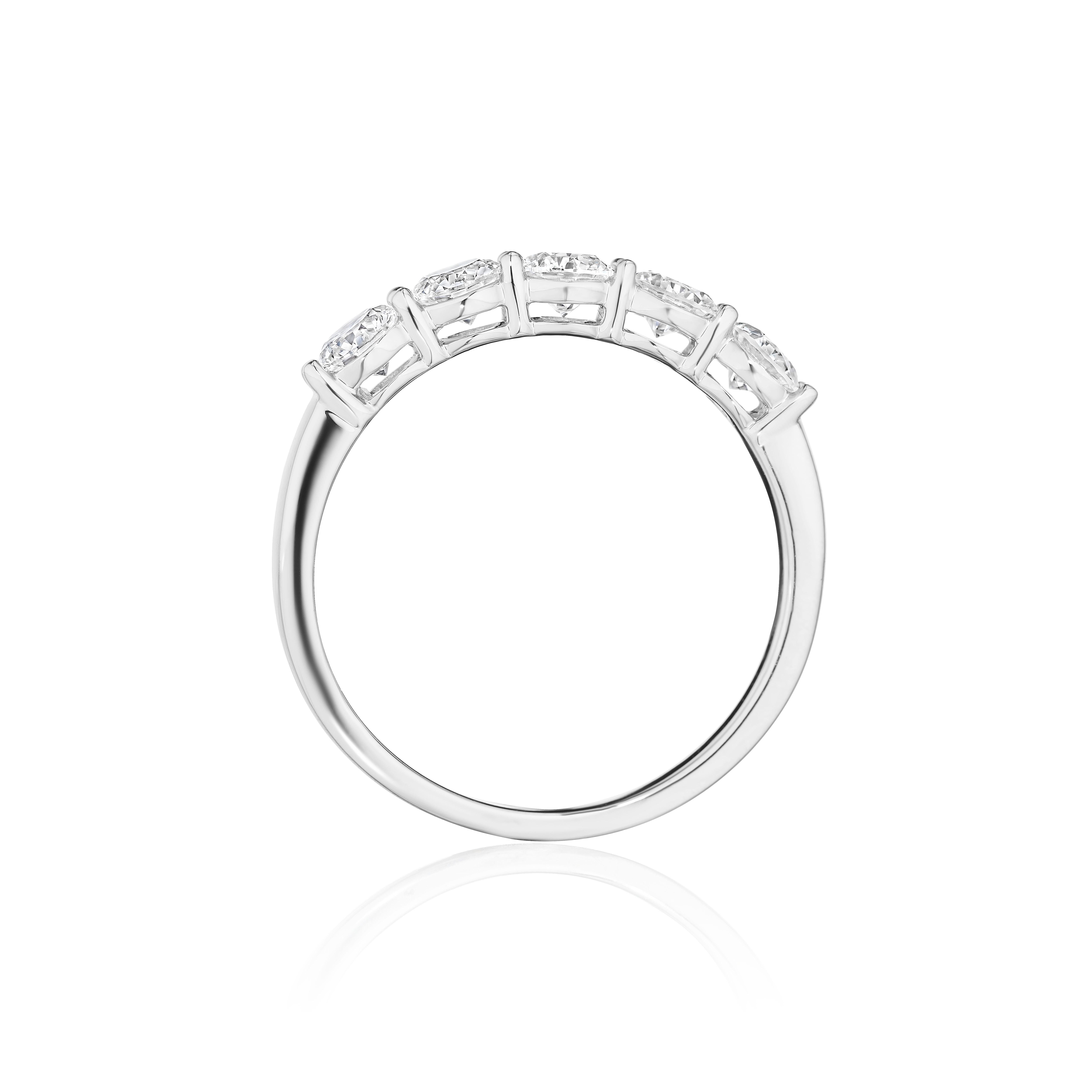 •	Crafted in 18KT gold, this band is made with 5 round brilliant cut diamonds, and has a combining total weight of approximately 1.00 carat. The diamonds are set into a shared prong setting.  Worn beautifully on its own or stacked.  A beautiful and