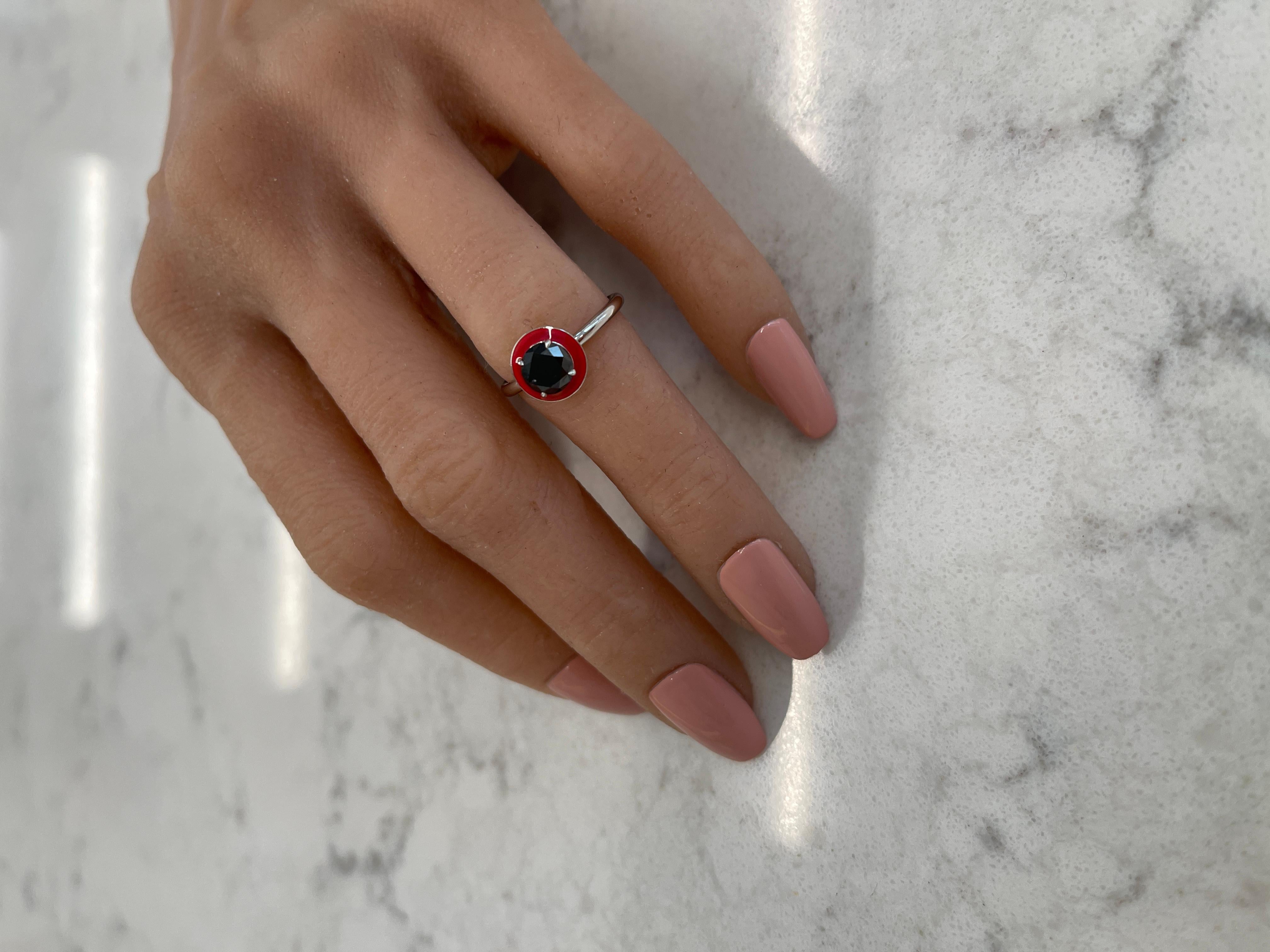 This intricate ring consists of a 1.00CT black diamond that has a red enamel halo surrounding it.