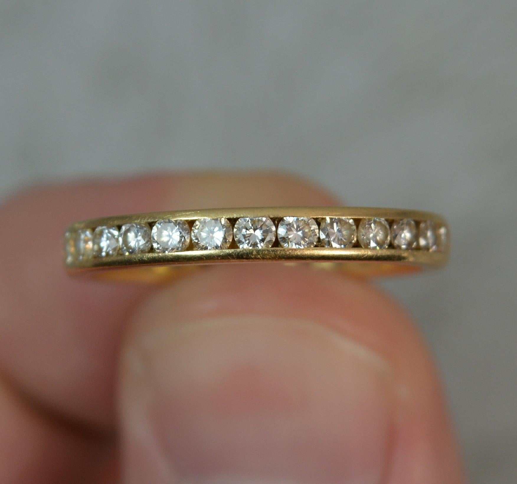 A superb natural diamond full eternity ring.
Modelled in 18 carat yellow gold throughout.
Set with many round cut diamonds. 1 carat total weight as confirmed to the shank.
2.75mm wide band. Protruding 1.6mm off the finger.

CONDITION ; Excellent.