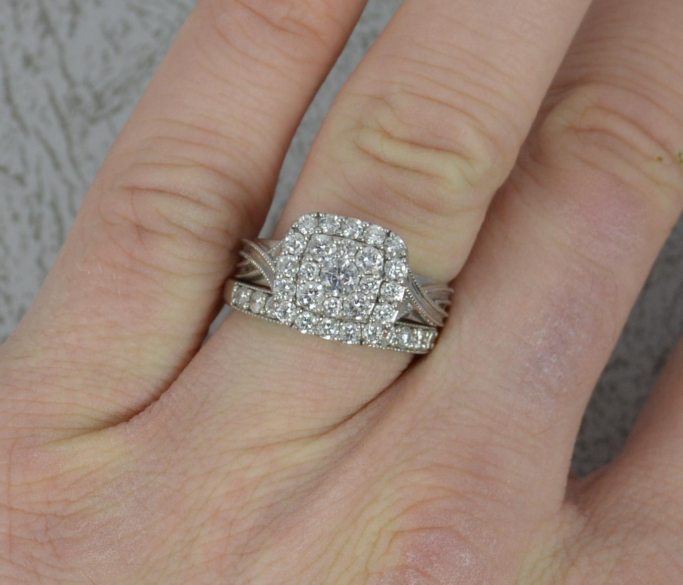 A superb modern bridal set comprising of two solid 9 carat white gold rings set with natural diamonds to total 1 carat.
The half eternity has 11 round brilliant cut diamonds in fine grain settings. 3mm wide to front.
The cluster is of a three tier