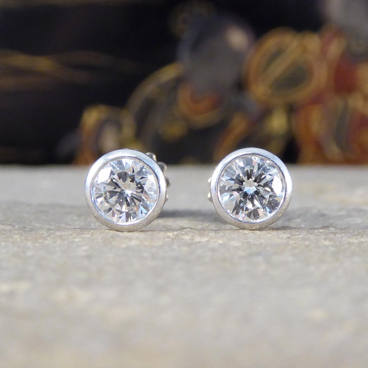 A beautifully bright and sparkly pair of Diamond stud earrings in 18ct White Gold with a secure and safe screw back, the perfect pair of earrings for those who like that extra security. Each stud holds a half carat round brilliant cut Diamond in a