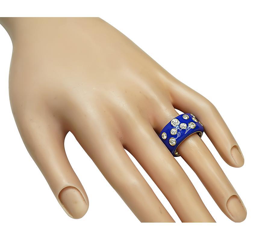 This is a charming enamel 14k yellow gold ring. The ring is set with sparkling round cut diamonds that weigh approximately 1.00ct. The color of these diamonds is G-H with VS clarity. The ring measures 12mm in width. The ring is stamped 14K and