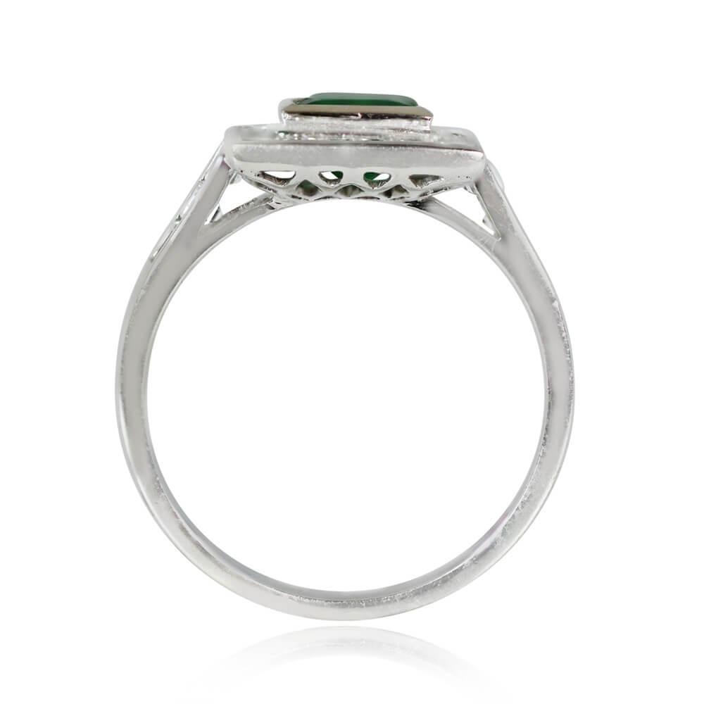A ring featuring a 1.00-carat emerald-cut emerald, bezel-set in 18k yellow gold and framed by a carre-cut diamond halo. Carre-cut diamonds also adorn the shoulders, with a total diamond weight of approximately 0.76 carats. Handcrafted in platinum