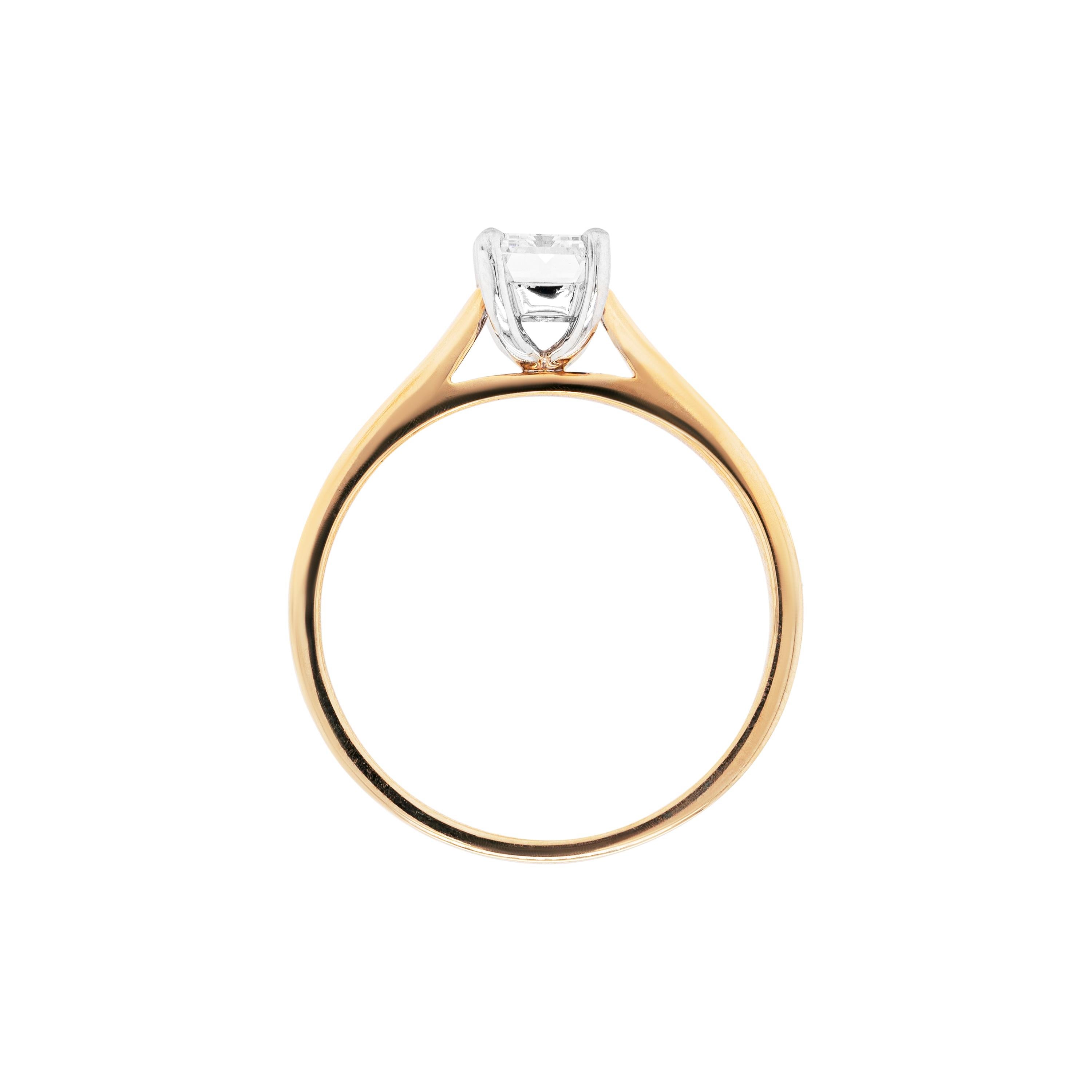 This dainty solitaire engagement ring features a certified 1.00 carat baguette cut diamond, graded F in colour and VS2 in clarity, mounted in an 18 carat white gold four claw, open back setting. The exquisite stone sits beautifully atop a