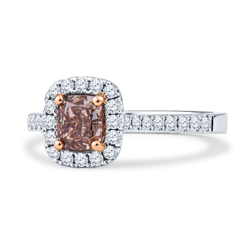 This 18kt white and rose gold cathedral-style engagement ring features a stunning GIA certified, cushion cut, 1.00 carat, SI1 clarity, fancy orangy brown diamond and 0.34ctw of split prong-set round brilliant diamonds in the halo. The ring is a size