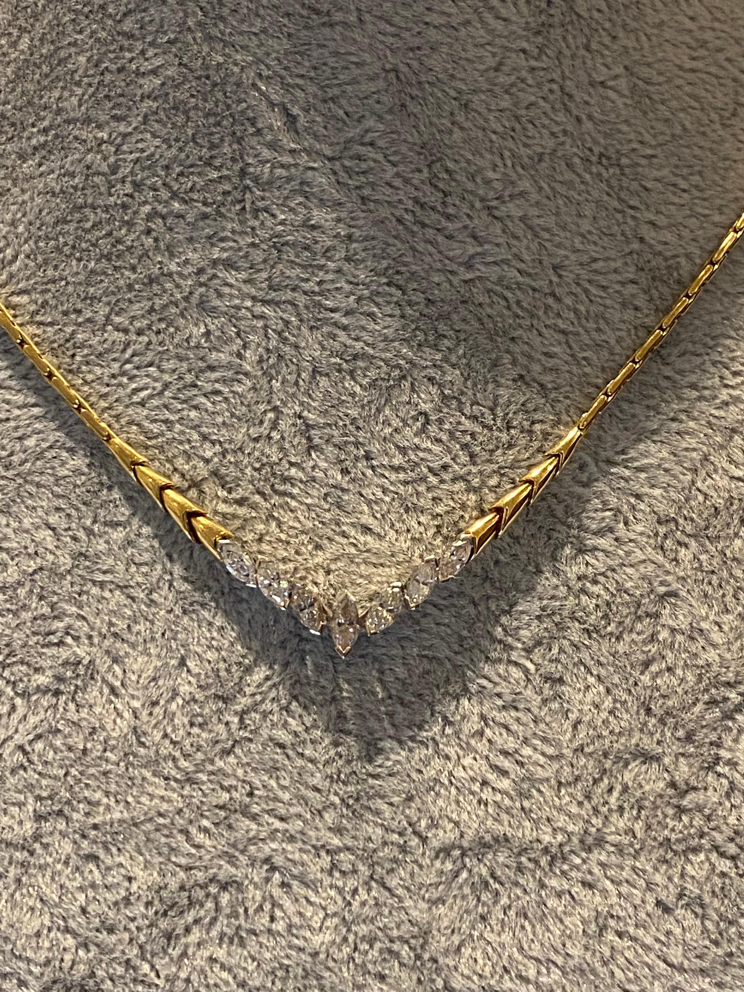 Visually-striking 18K yellow & white gold necklet 
of choker size 
featuring an elegant V-shaped drop, 
approx. 2.5cm long
Adorned with 7 natural sparkling diamonds
of desirable marquise shape 
(with the centre measuring 7mm x 2.5mm approx.)
of