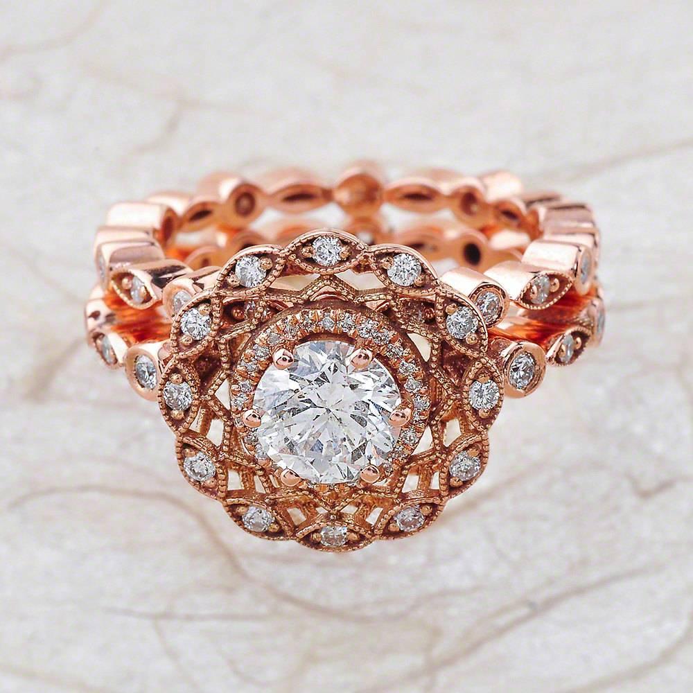 - Center Stone: Round Cut Moissanite 6mm (1.00ct)
- Side Stones: Round Cut Diamonds 0.65ctw / Graded G SI1
- Metal: 14K Rose Gold

This piece is made-to-order. Please allow up to 7 Business Days to accomplish.