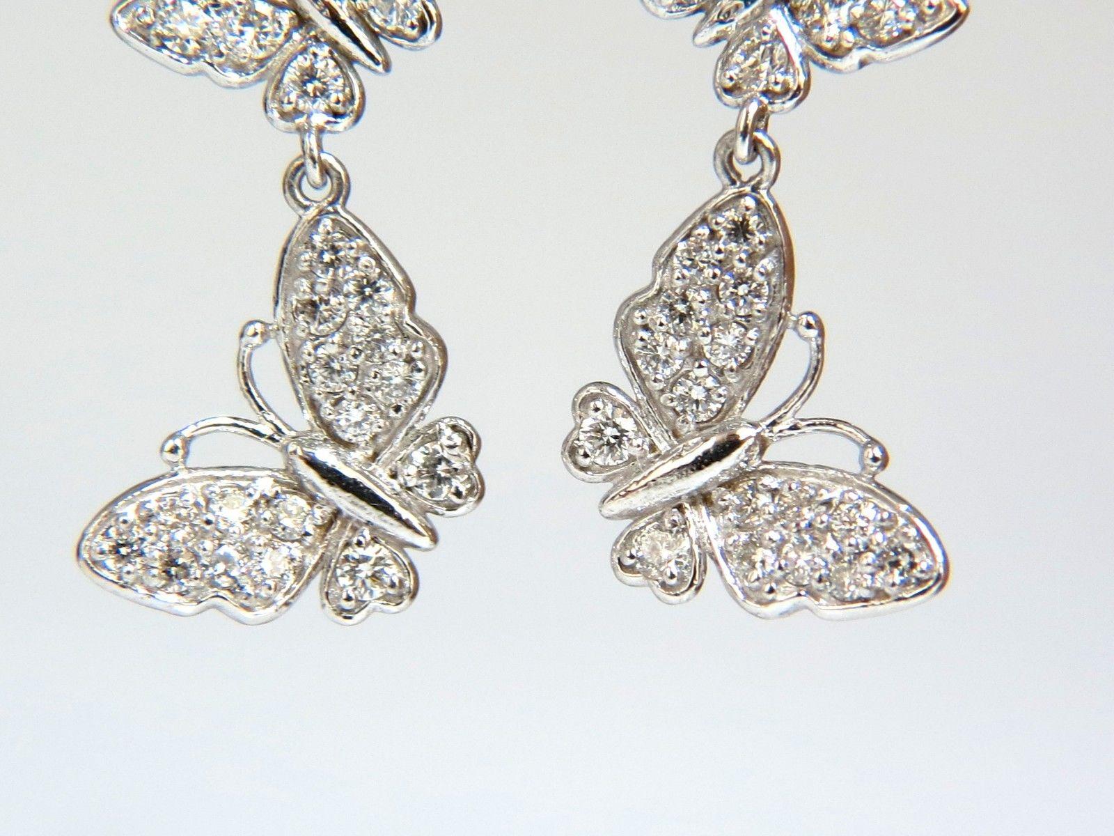 Butterflies Dangling

1.00ct. Natural diamonds  

Rounds, Full cut brilliants.

G- color Vs-2  Clarity. 

Secure lever on hoops

Excellent detail.

14kt. white gold

5.5 grams.

1.5 inch long

 .50 Inch Diameter of larger butterfly at lower