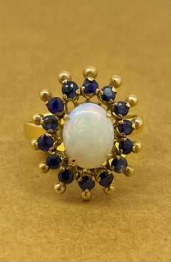 1.00ct Solid Australian Oval Opal & Sapphire Halo Dress Ring in 18K Yellow Gold.