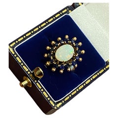 1.00ct Solid Australian Oval Opal & Sapphire Halo Dress Ring in 18K Yellow Gold.