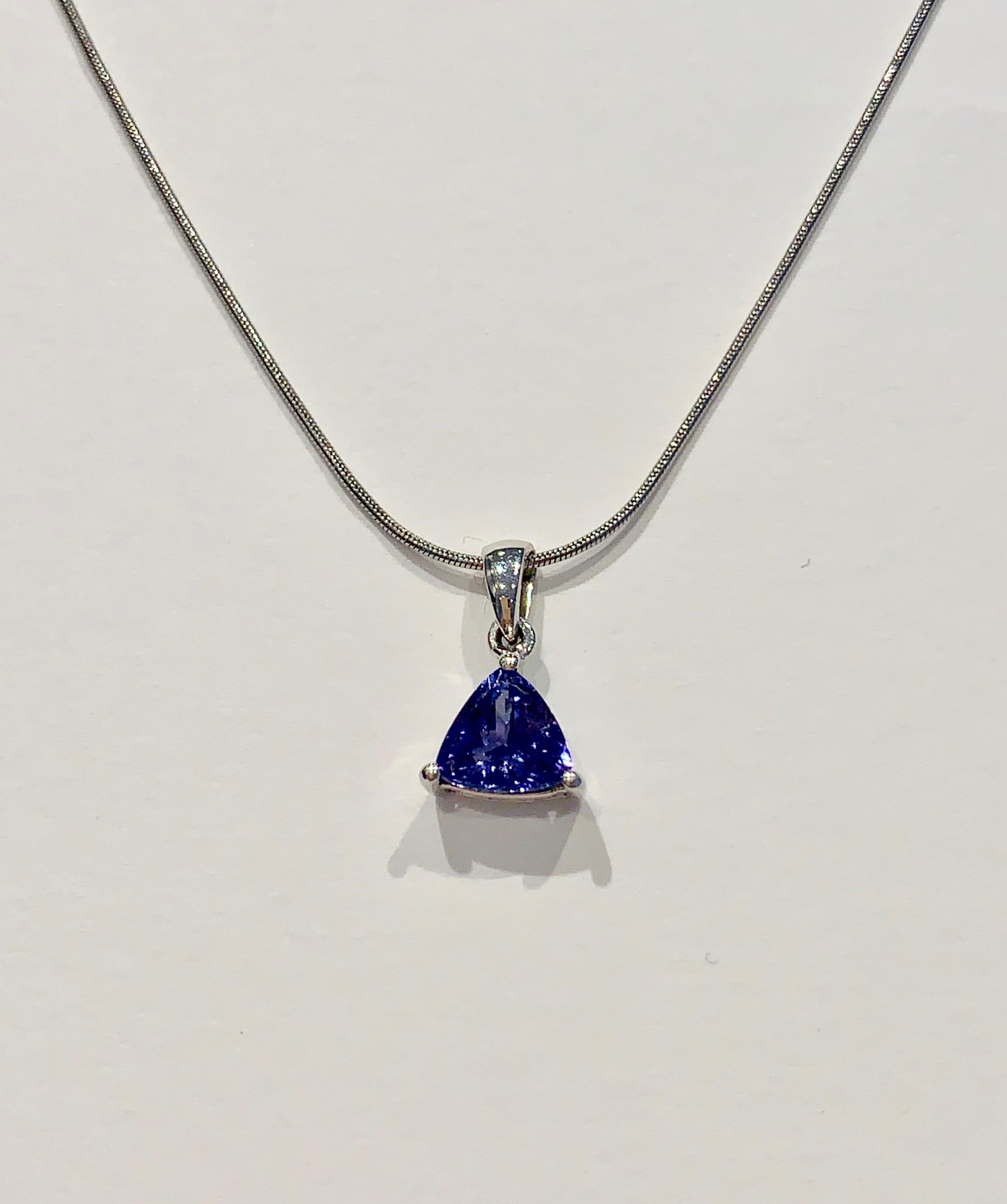 This delicate Pendant has a pretty blue Trillion cut Tanzanite stone set in 18ct White Gold.  The Tanzanite has wonderful clarity and sparkle.  The stone measures 7  x 7 mm and is presented on an 18 inch White Gold Snake Chain. 

The chain has a