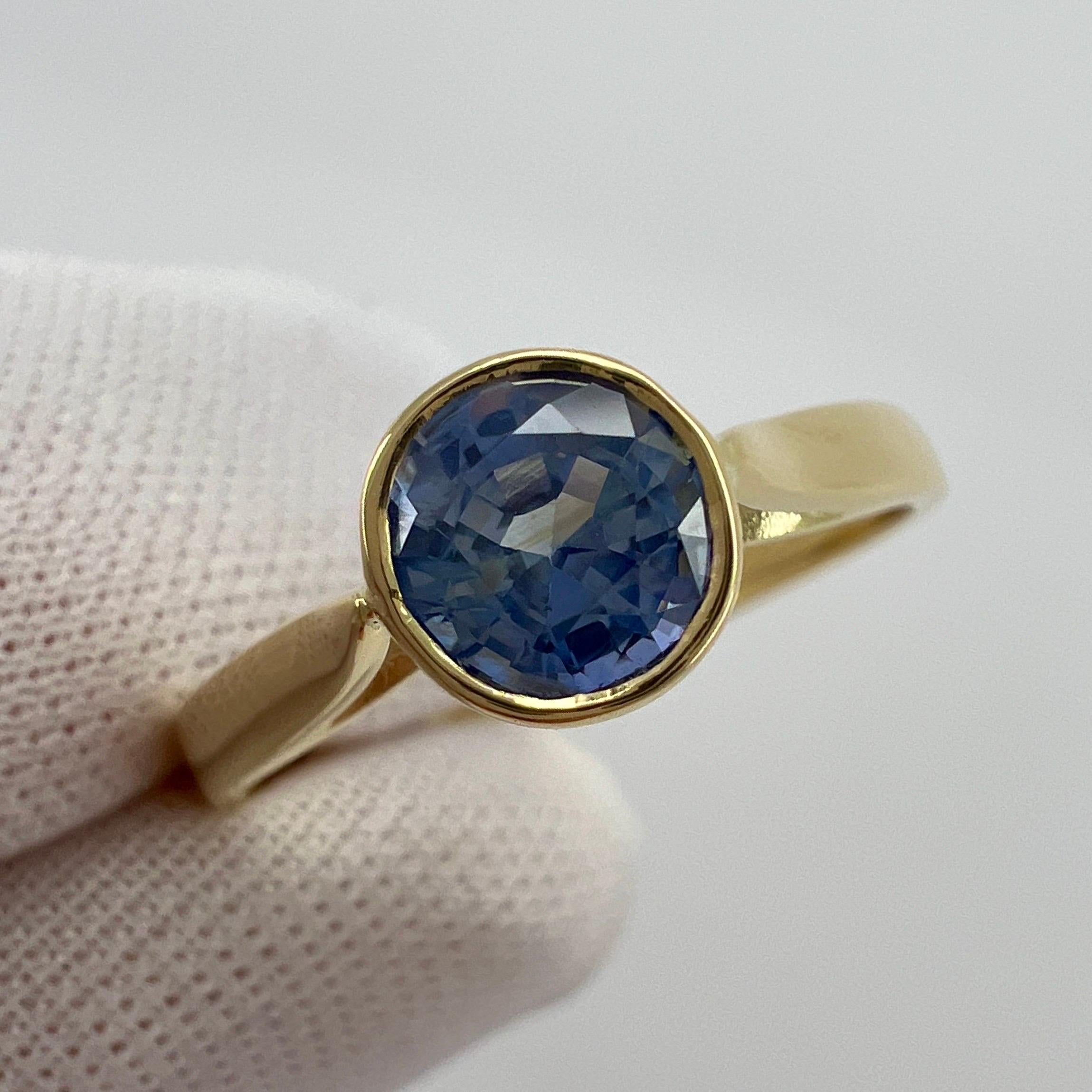Vivid Light Blue Ceylon Sapphire Round Cut 18k Yellow Gold Solitaire Rubover Bezel Set Ring.

1.00 Carat sapphire with a stunning vivid light blue and good clarity. Clean stone with only some small natural inclusions visible when looking closely. No
