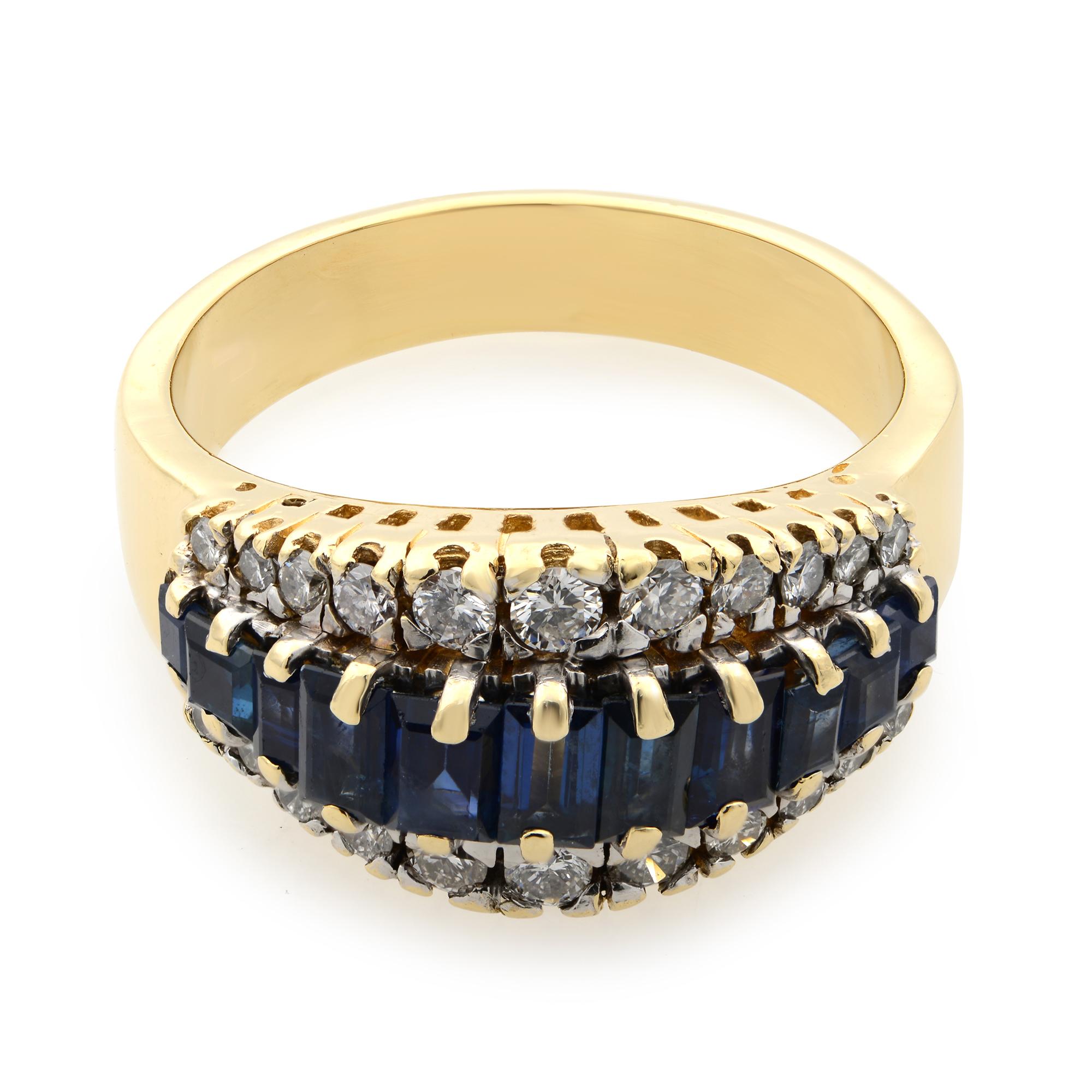 This beautiful blue sapphire and diamond cocktail ring is crafted in fine 14k yellow gold. An excellent 11 prong set emerald cut blue sapphires are flanked as a center row with 22 round brilliant cut diamond outline. Diamond color H and SI-I