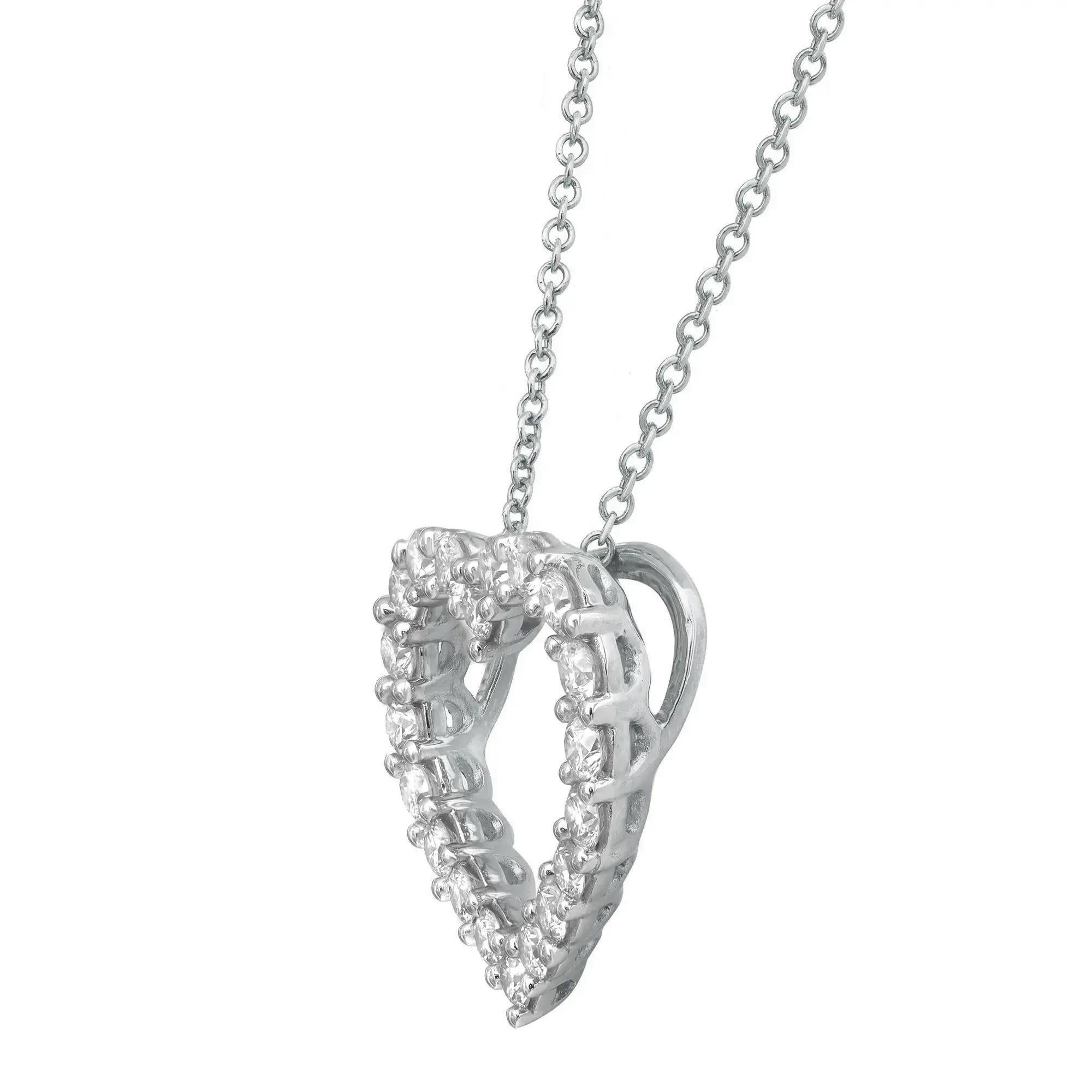 This classic natural diamond heart pendant showcases prong set white sparkling round cut diamonds in a heart-shaped cut out design. Crafted in 14K white gold. Total diamond weight: 1.00 carat. Each diamond is of VS-SI clarity and G-H color. This