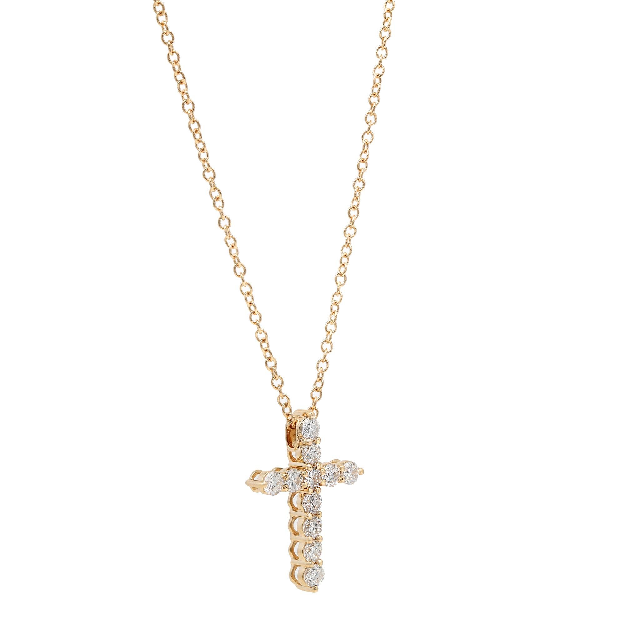 This gorgeous 18K yellow gold diamond cross pendant features 11 prong set round brilliant cut sparkling diamonds weighing approximately 1.00 carat in total. Diamond quality: G-H color and VS-SI clarity. Pendant size: 21.9mm x 16.2mm. Chain length: