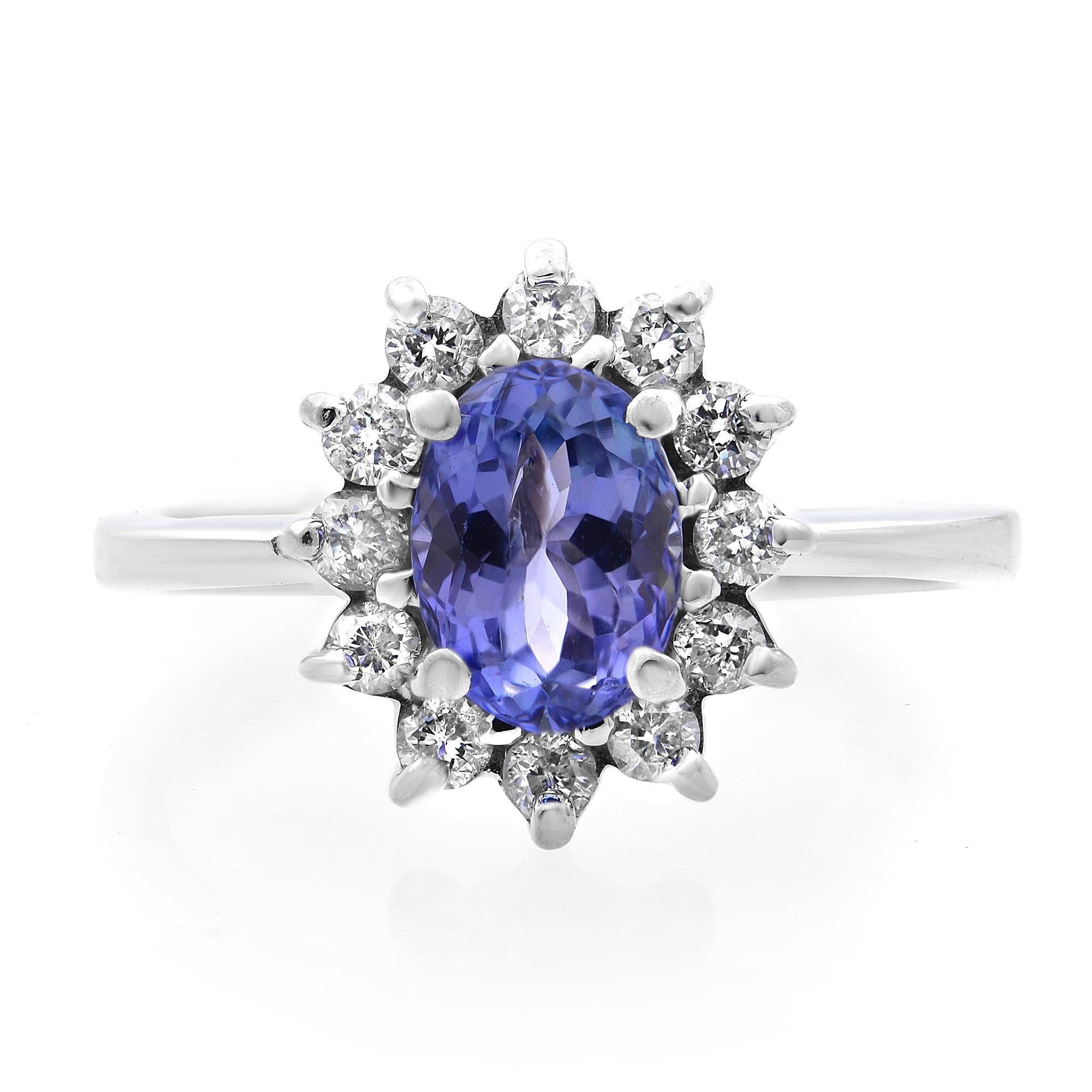This stunning Tanzanite and diamond flowering halo engagement anniversary ring is encrusted with 1.00 carat blue tanzanite and encircled with 0.60 carat white round cut diamonds in 14k white gold setting. This timeless design is perfect as a