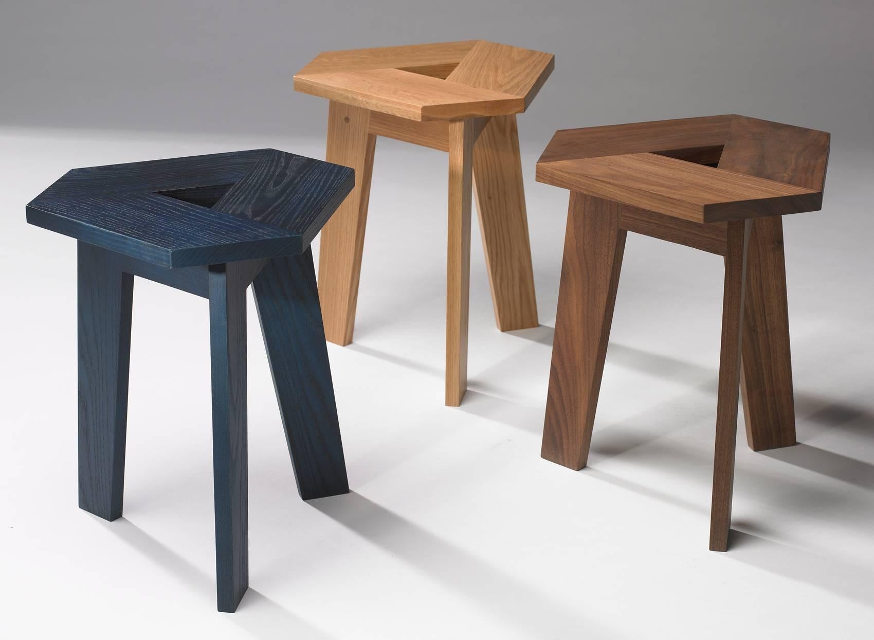 A very adaptable stool or side table in solid walnut - custom finishes and other woods available. A minimal design which is comprised of three separate pieces repeated three times and the hand hold in the middle allows for easy movement around the