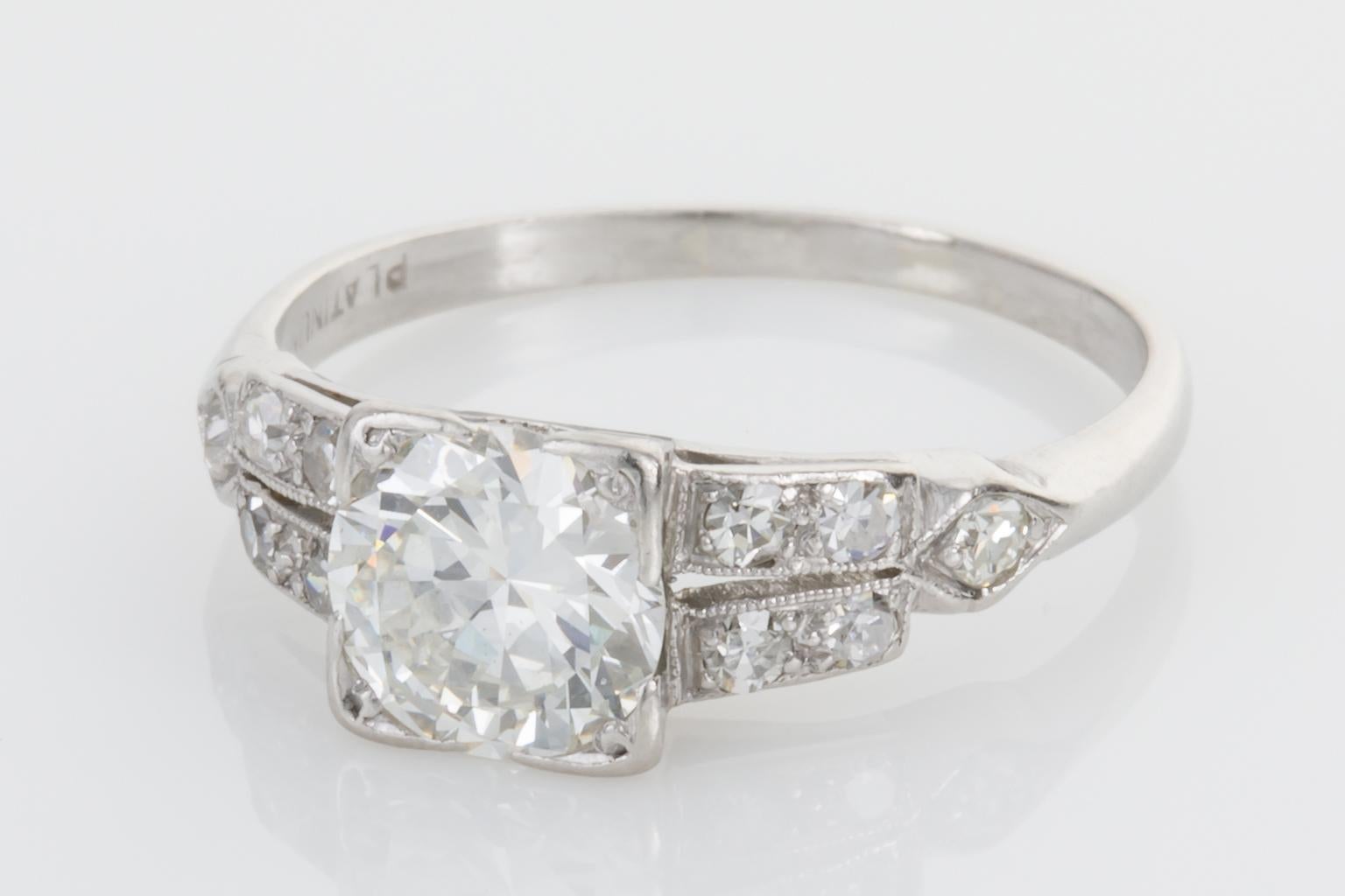 Original and timeless, this pretty Art Deco ring is perfect as an engagement ring, set with an old European cut diamond to the centre weighing approximately 1.01ct framed in a square bezel mounting, the split shoulders of the ring are also adorned