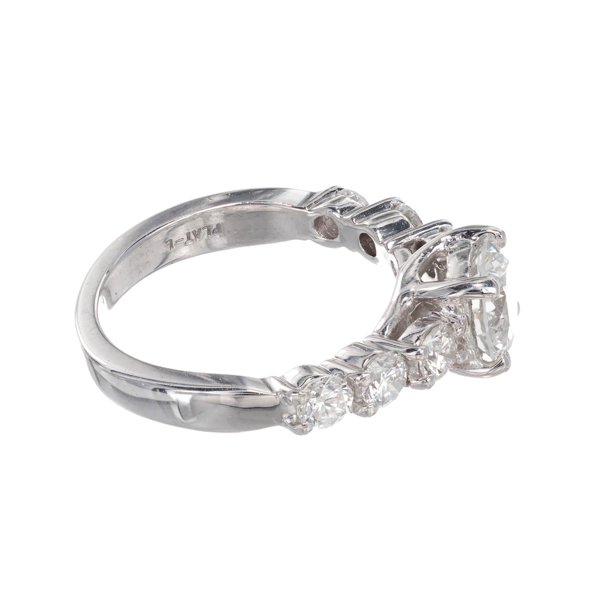 Platinum diamond engagement ring. Center round brilliant cut diamond is accented with three additional round brilliant cut diamonds on either side in a step platinum setting.

1 round brilliant cut H-I VS diamonds Approximate 1.01 carats
6 round