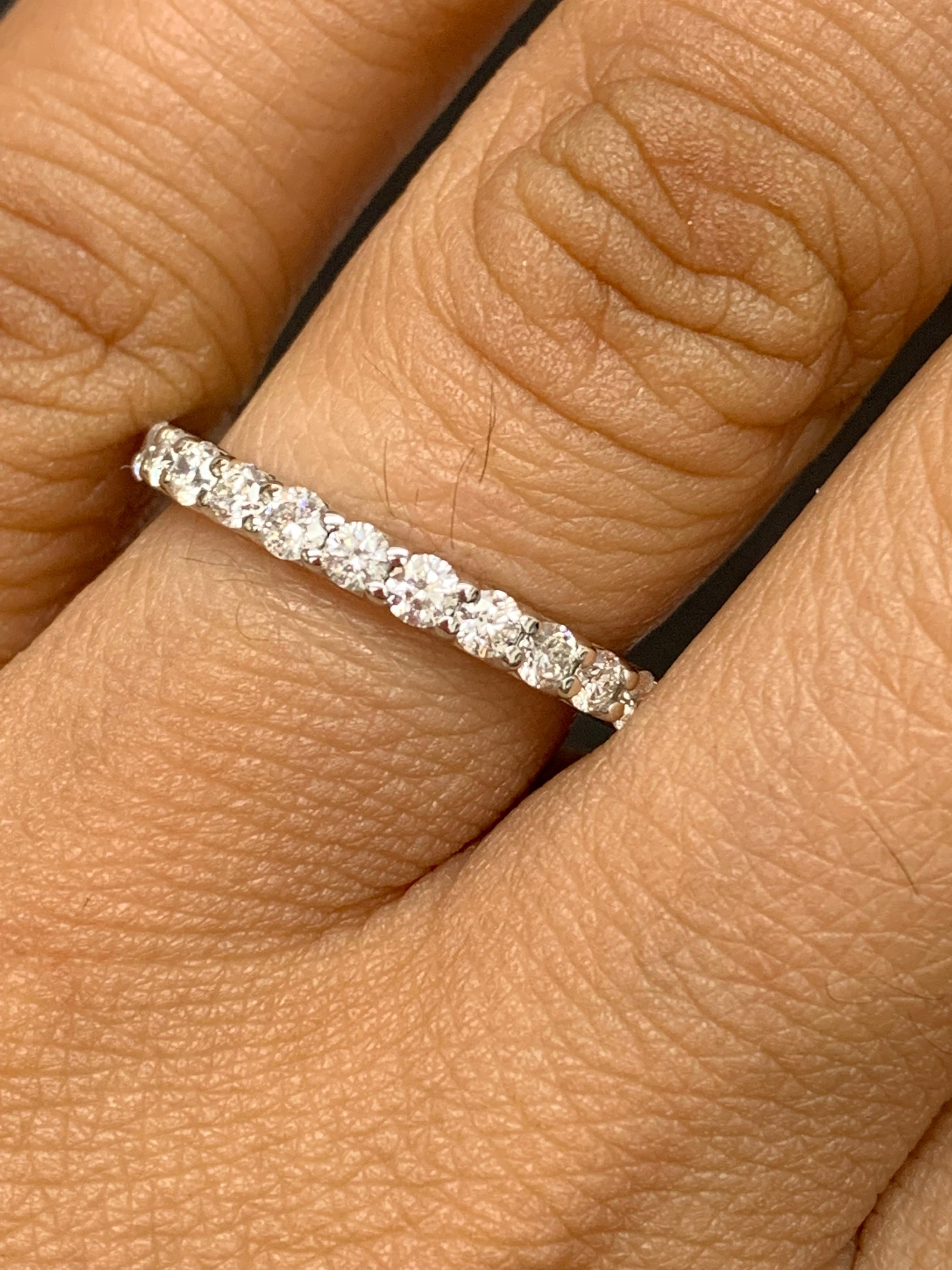 A classic and timeless eternity band style showcasing a row of round brilliant diamonds set in a shared prong 14K white gold mounting. 27 Diamonds weigh 1.01 carats. Size 6.5 US.

Style is available in different price ranges. Prices are based on
