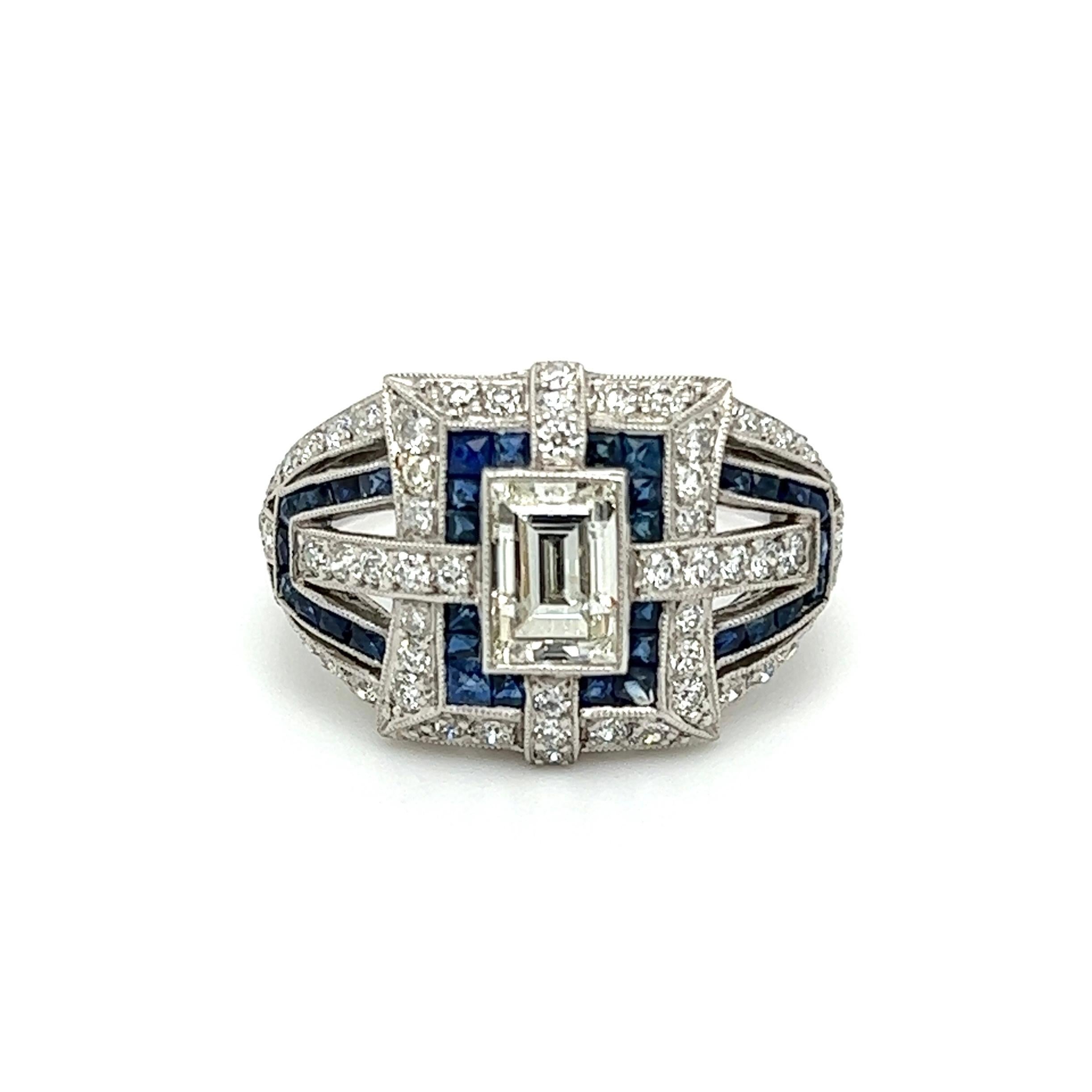 Simply Beautiful! Diamond and Sapphire Art Deco Revival Platinum Cocktail Ring. Centering a securely nestled Hand set Carré Diamond weighing approx. 1.01 Carat. Surrounded by Sapphires approx. 1.20tcw and Diamonds approx. 0.81tcw. Hand crafted