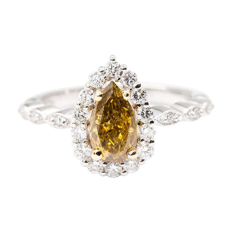 1.01 Carat Certified Fancy Yellow Pear Diamond and 0.42 Carat Engagement Ring For Sale