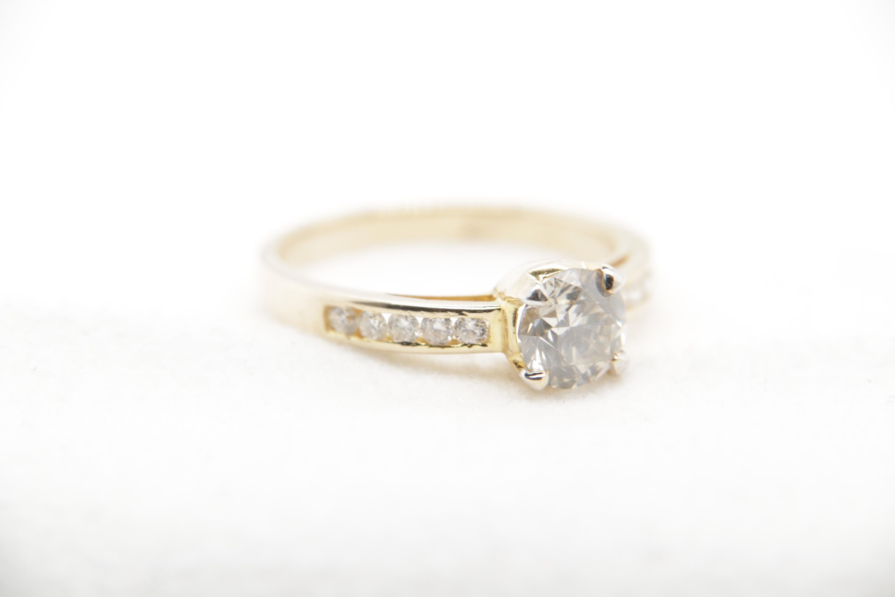 A brand new diamond ring in 18 karat gold. The total diamond weight is 1.01 carat and total ring weight is 3.05 grams.