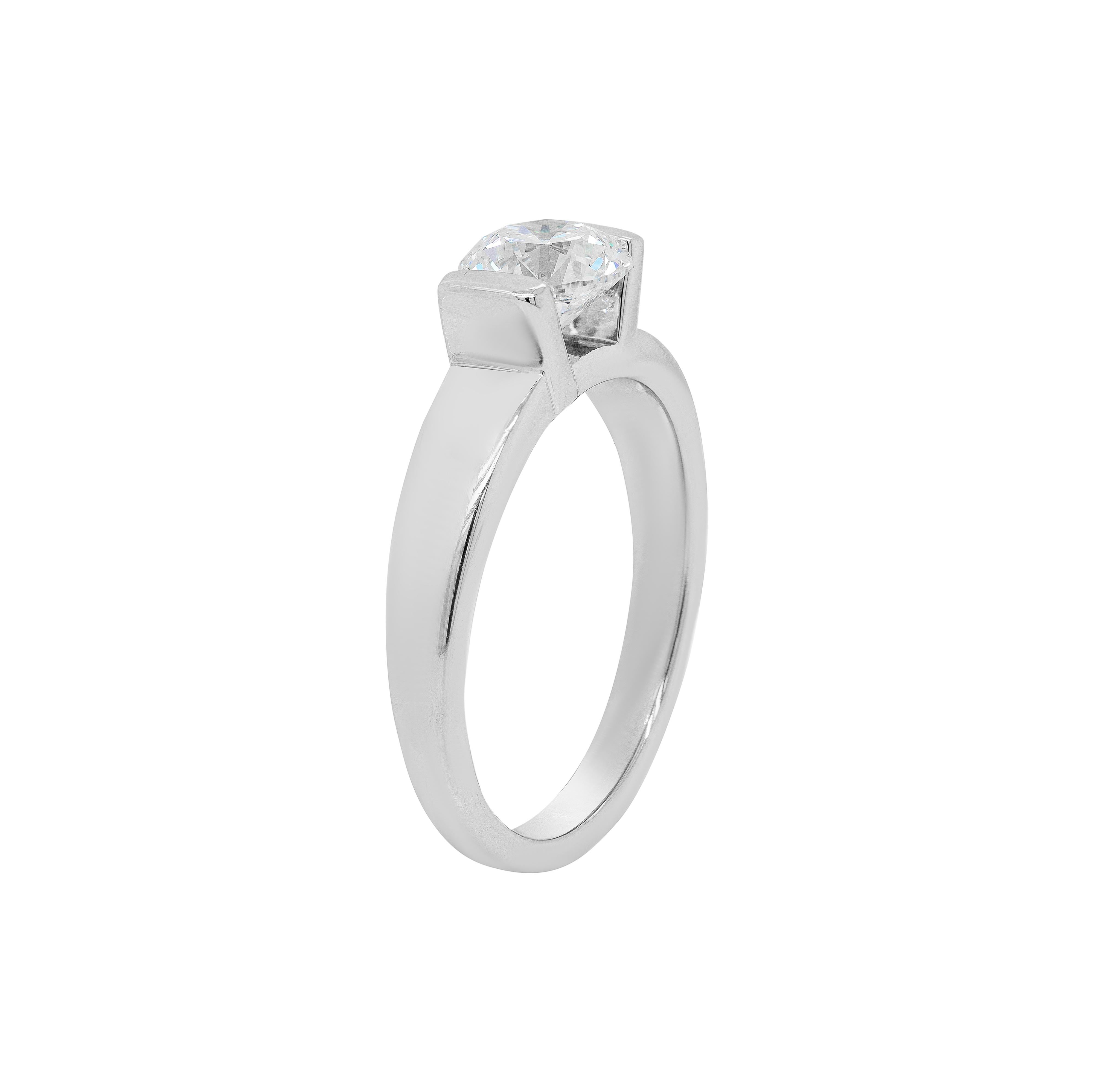 This exquisite engagement ring features a wonderful 1.01ct round brilliant cut diamond, certified E in colour and VS2 in clarity, that is beautifully mounted in a high semi rub-over setting. The beautiful piece is completed by a perfectly crafted